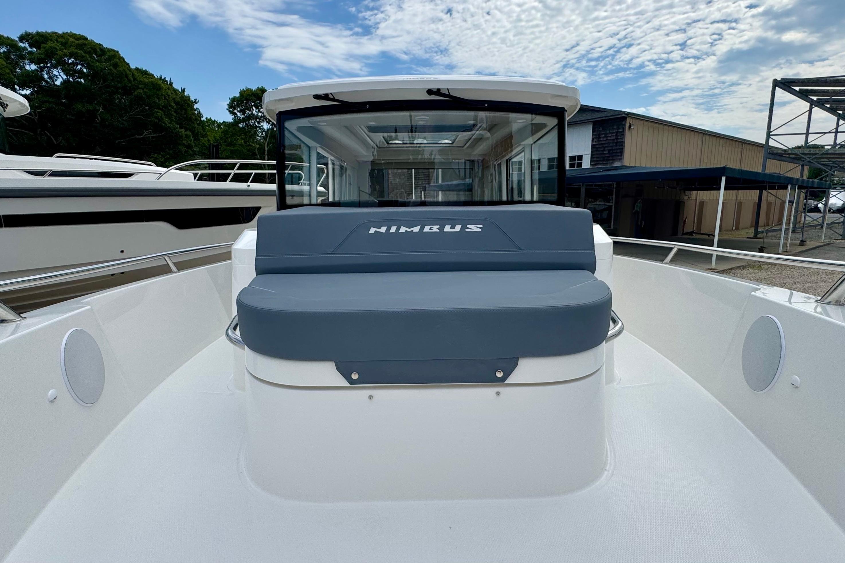 The image shows a 2026 Nimbus Commuter 9 boat with a modern design and spacious deck.