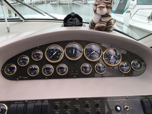 Dashboard of a 2004 Cruisers Yachts 3372 Express with plush toy.
