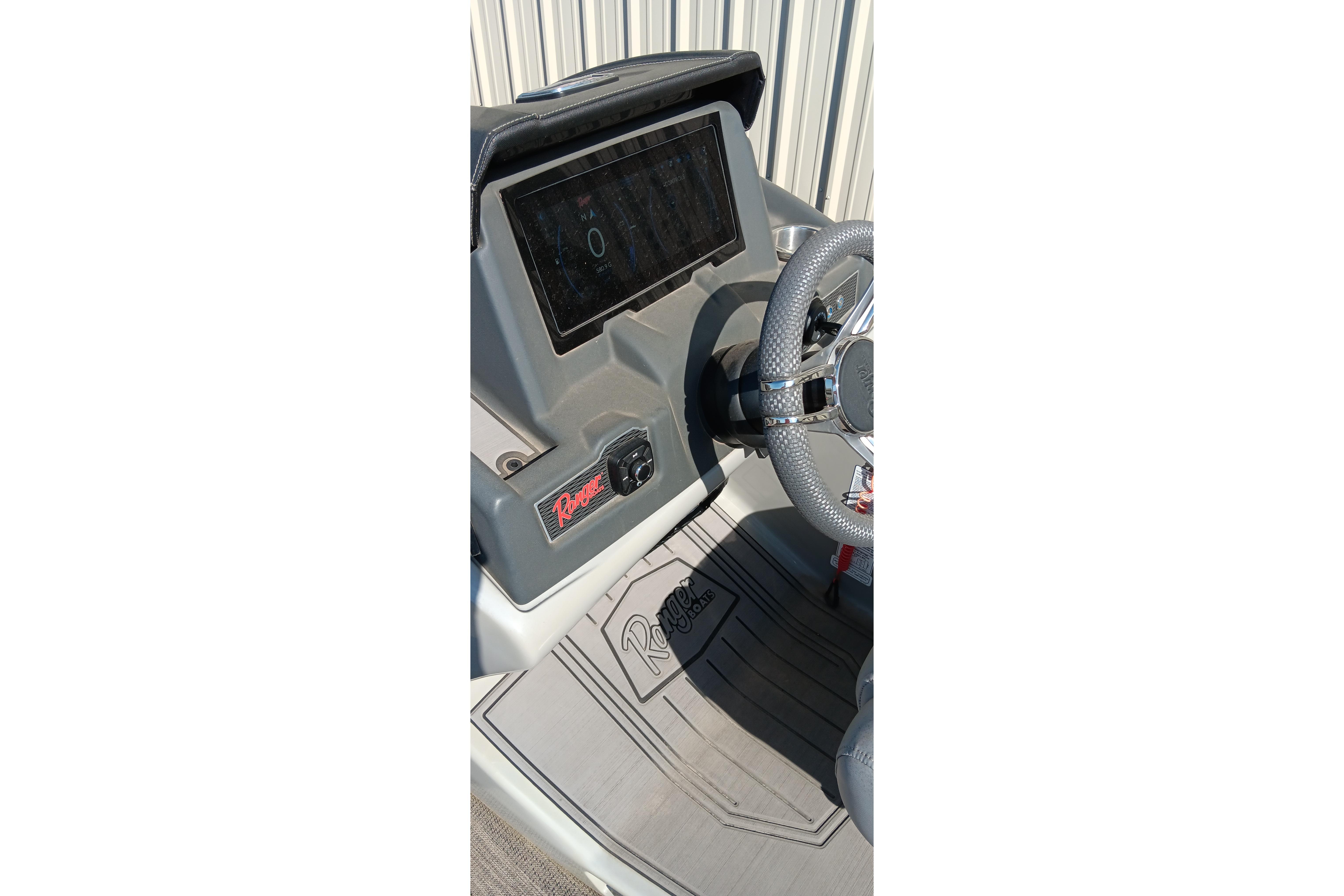 Dashboard of 2023 Ranger 2500LS boat with steering wheel and control panel.