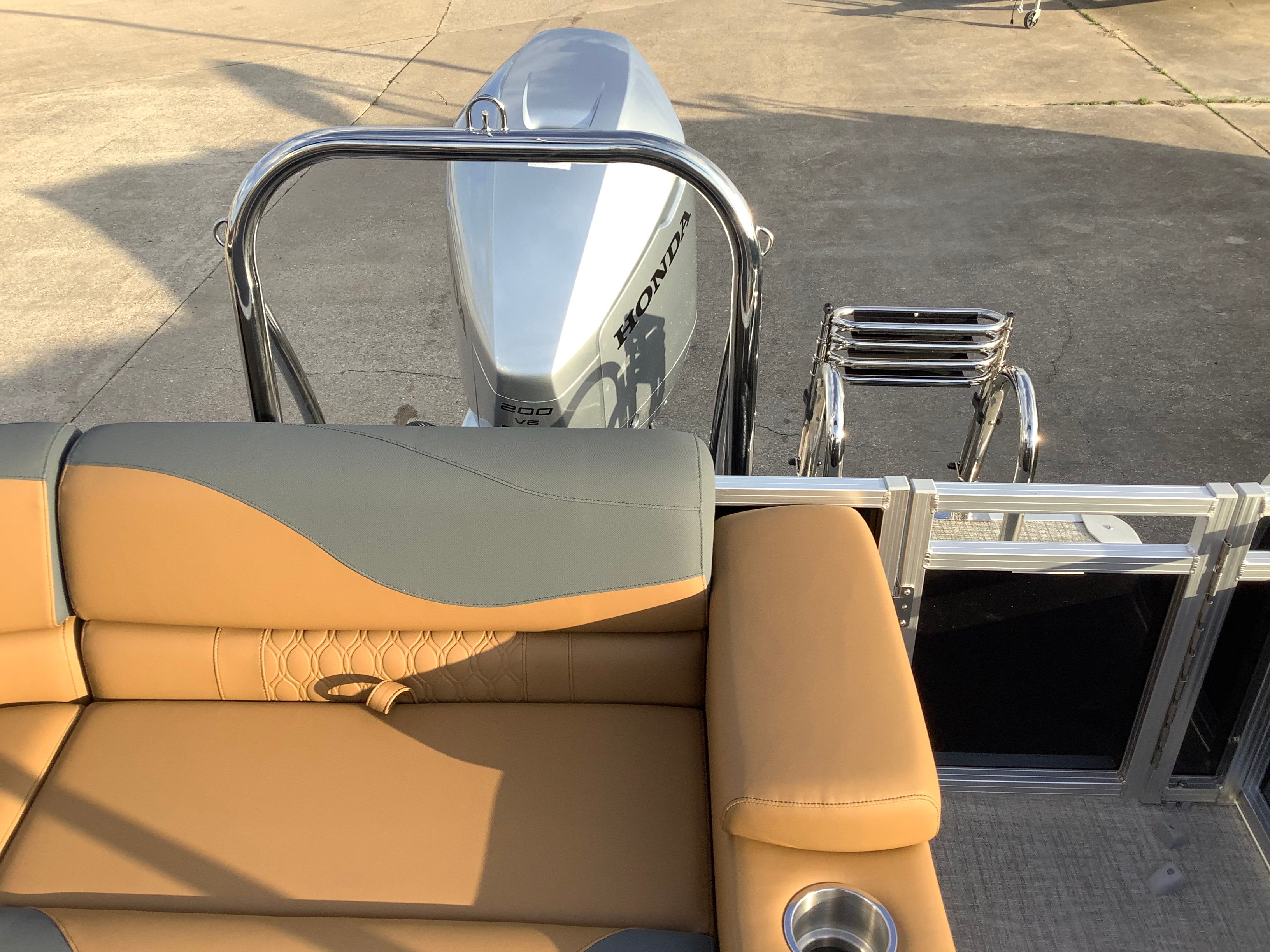 2026 Tahoe 2385 LTZ boat with Honda engine and beige seating.