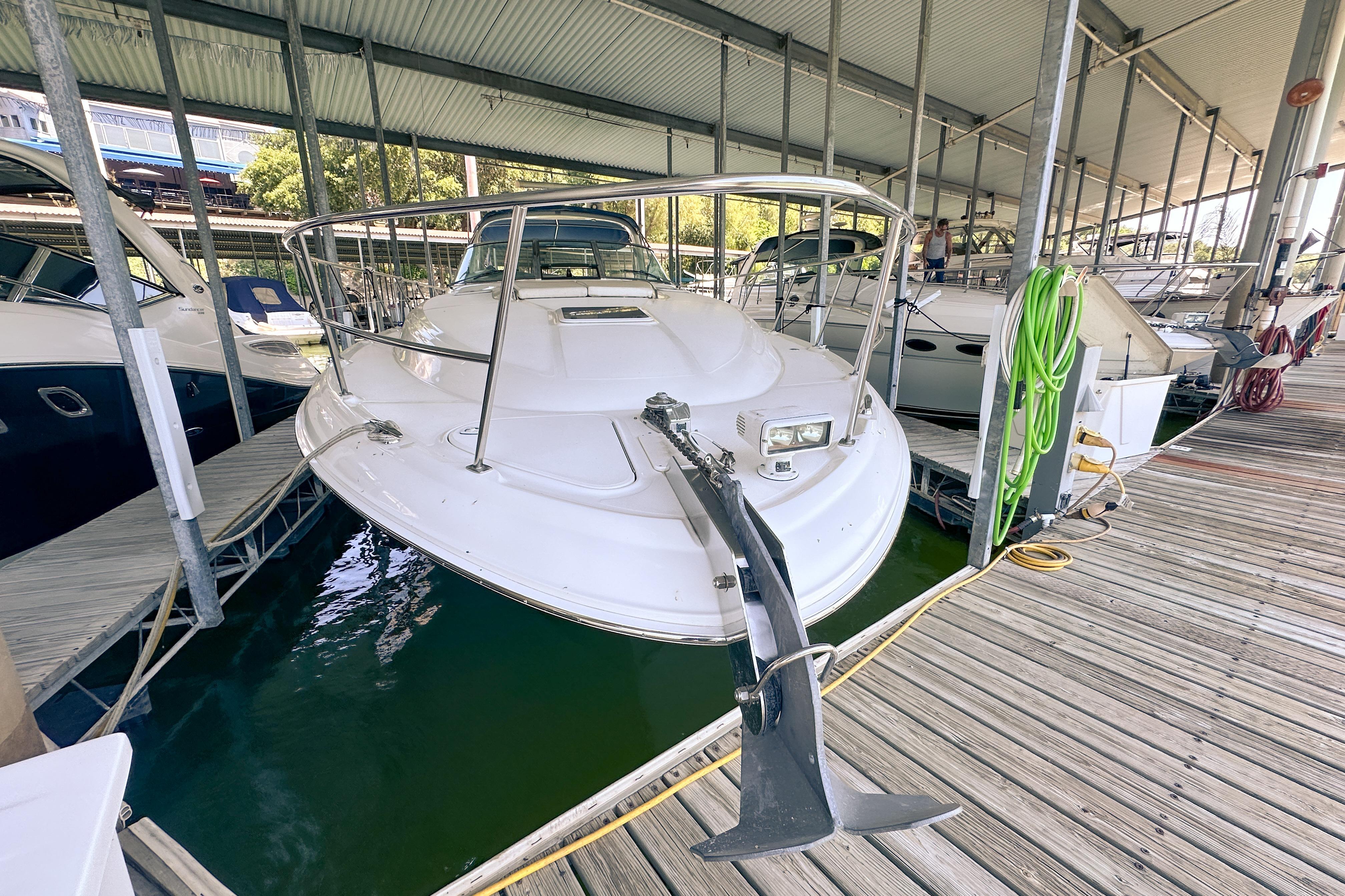 2001 Sea Ray 410 Sundancer yacht docked in a marina under a covered shelter.