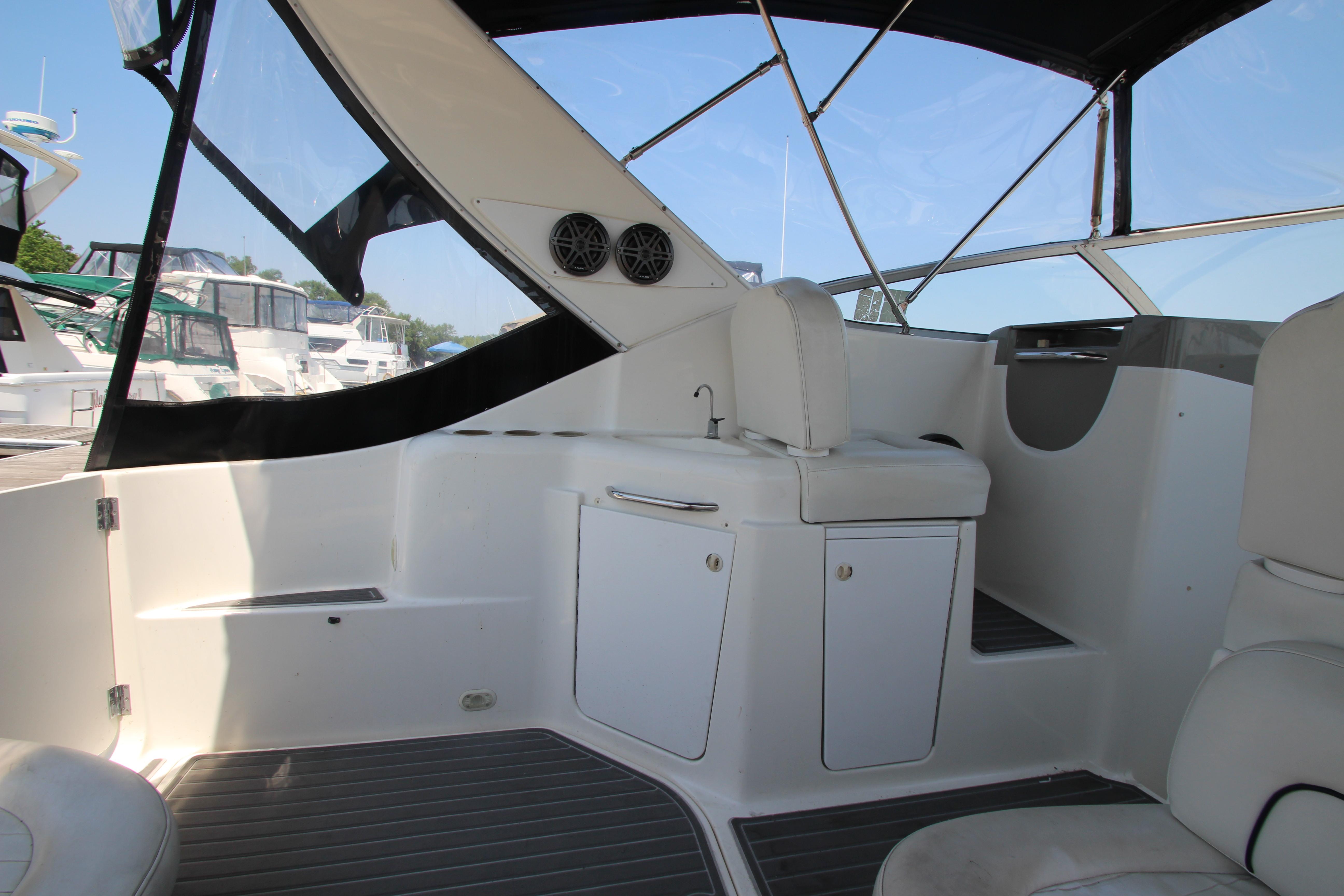 1999 Bayliner 3055 Ciera boat interior with seating and storage, docked at marina.