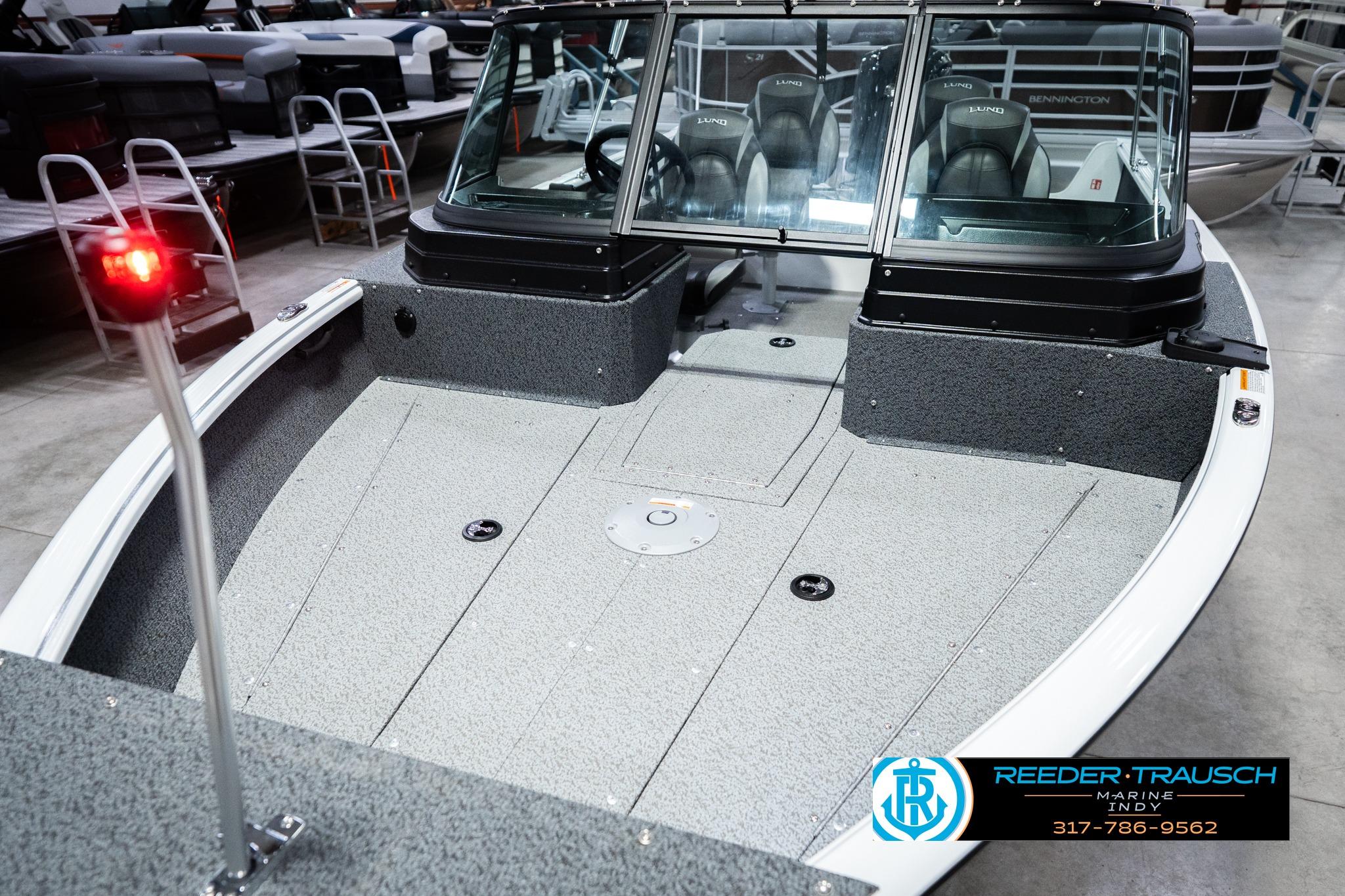 2026 Lund 1700 Explorer Sport boat interior with seating and windshield in showroom.