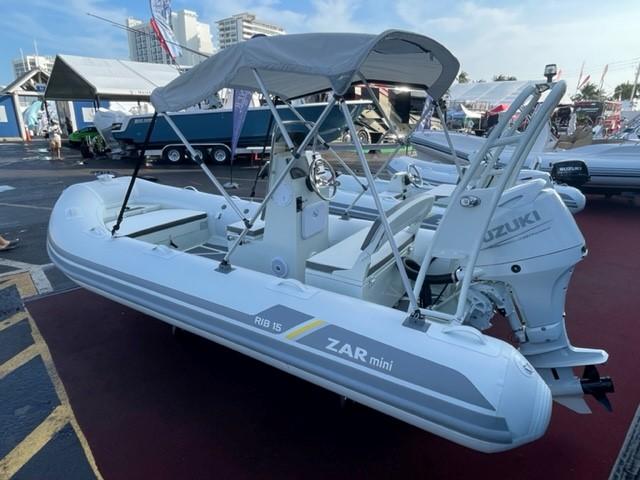 2024 ZAR Mini RIB 15 Tender with Suzuki outboard motor, displayed at a boat show.