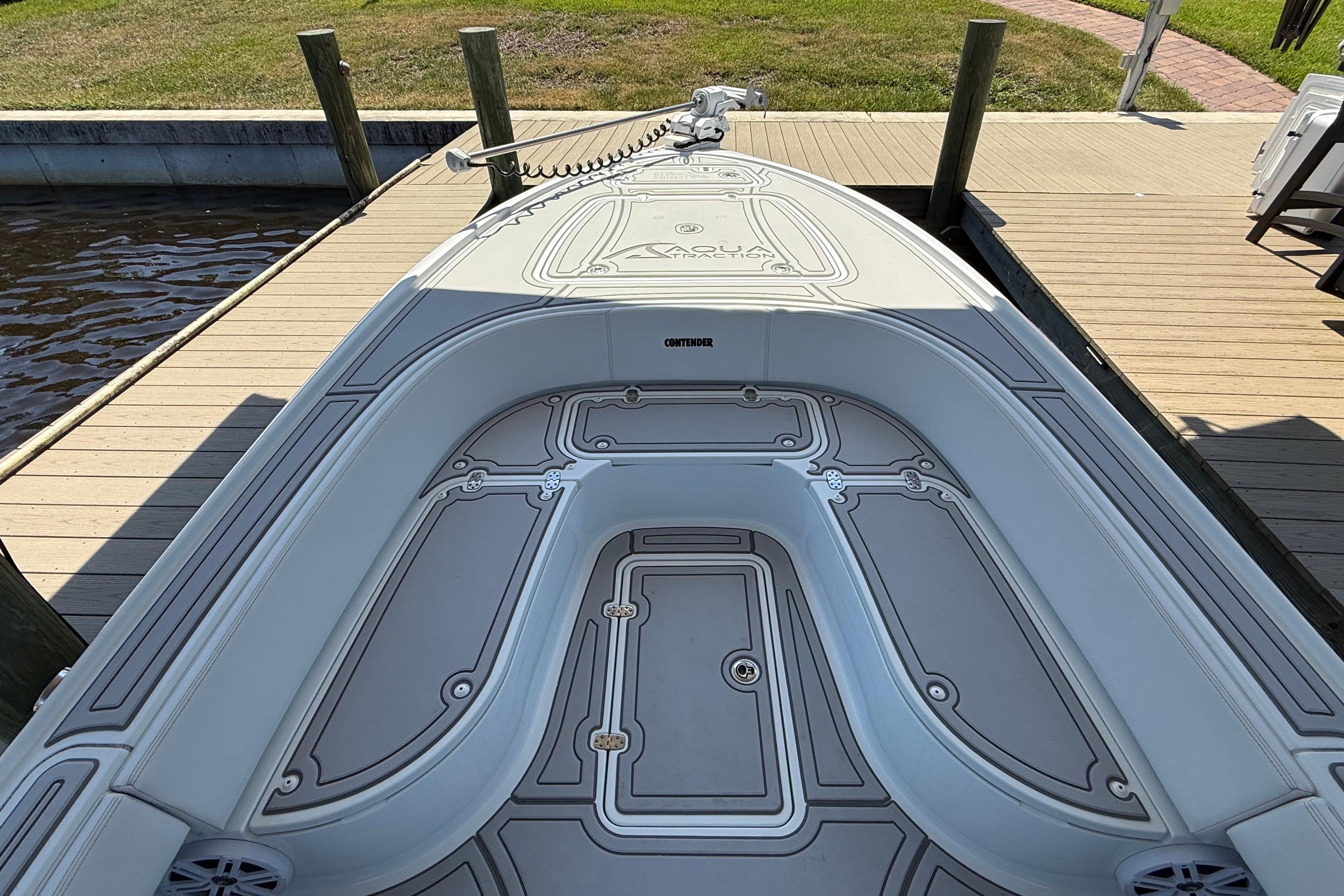 2024 Contender 26 Bay boat docked, showcasing sleek deck design and spacious seating.