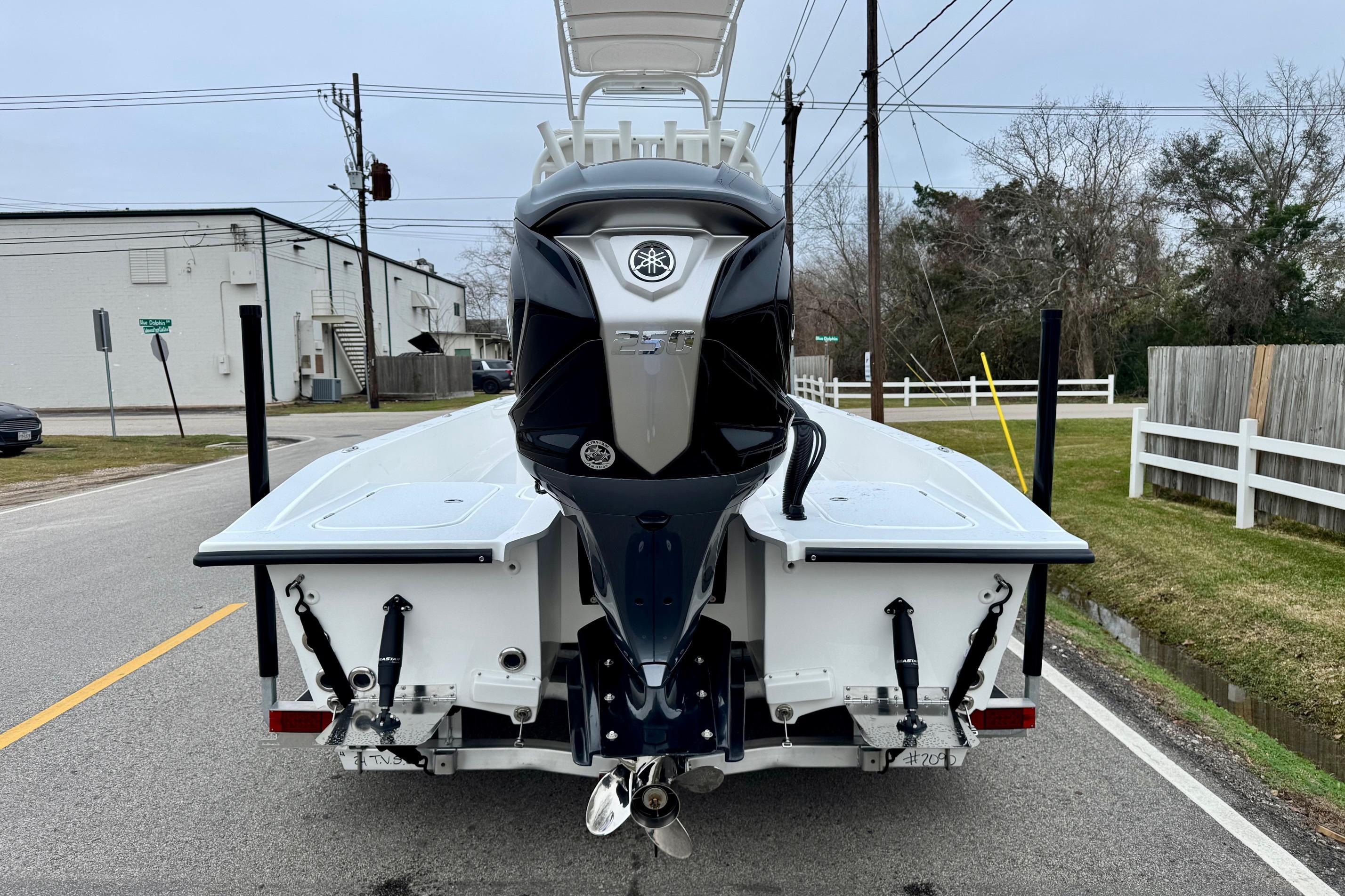 2026 Shallow Sport 24 Modified V boat with powerful outboard motor on a street.