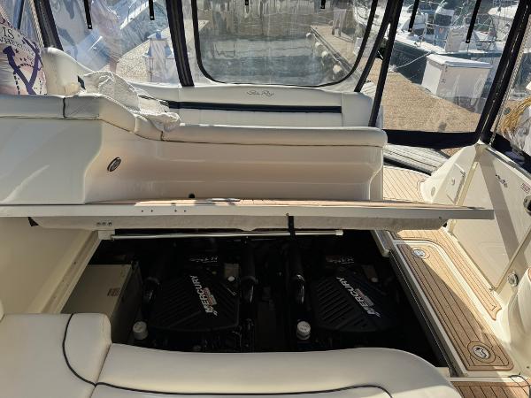 2004 Sea Ray 390 Sundancer engine compartment with twin Mercury engines visible.