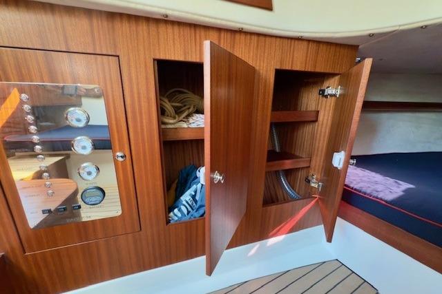 Interior of 2024 Leonardo Yachts Eagle 38, featuring wooden cabinetry and storage compartments.