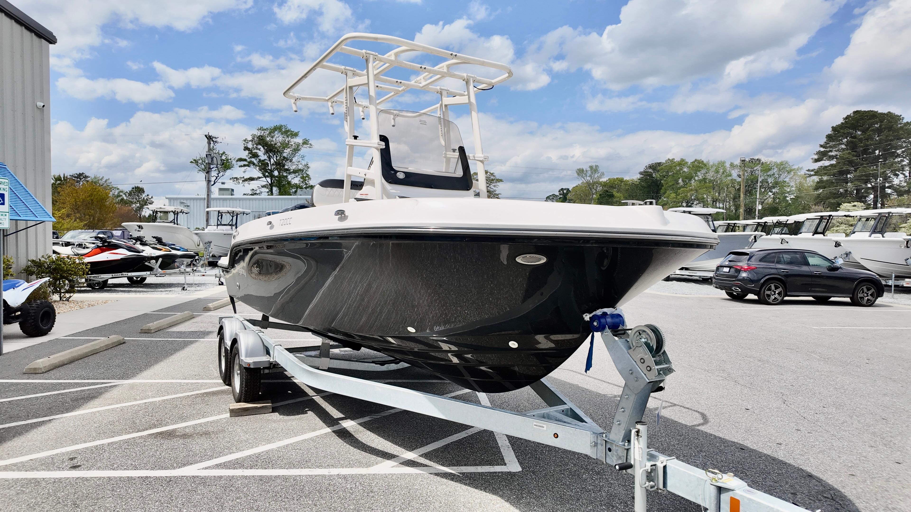 2025 Bayliner Trophy 20 boat on trailer in parking lot under cloudy sky.