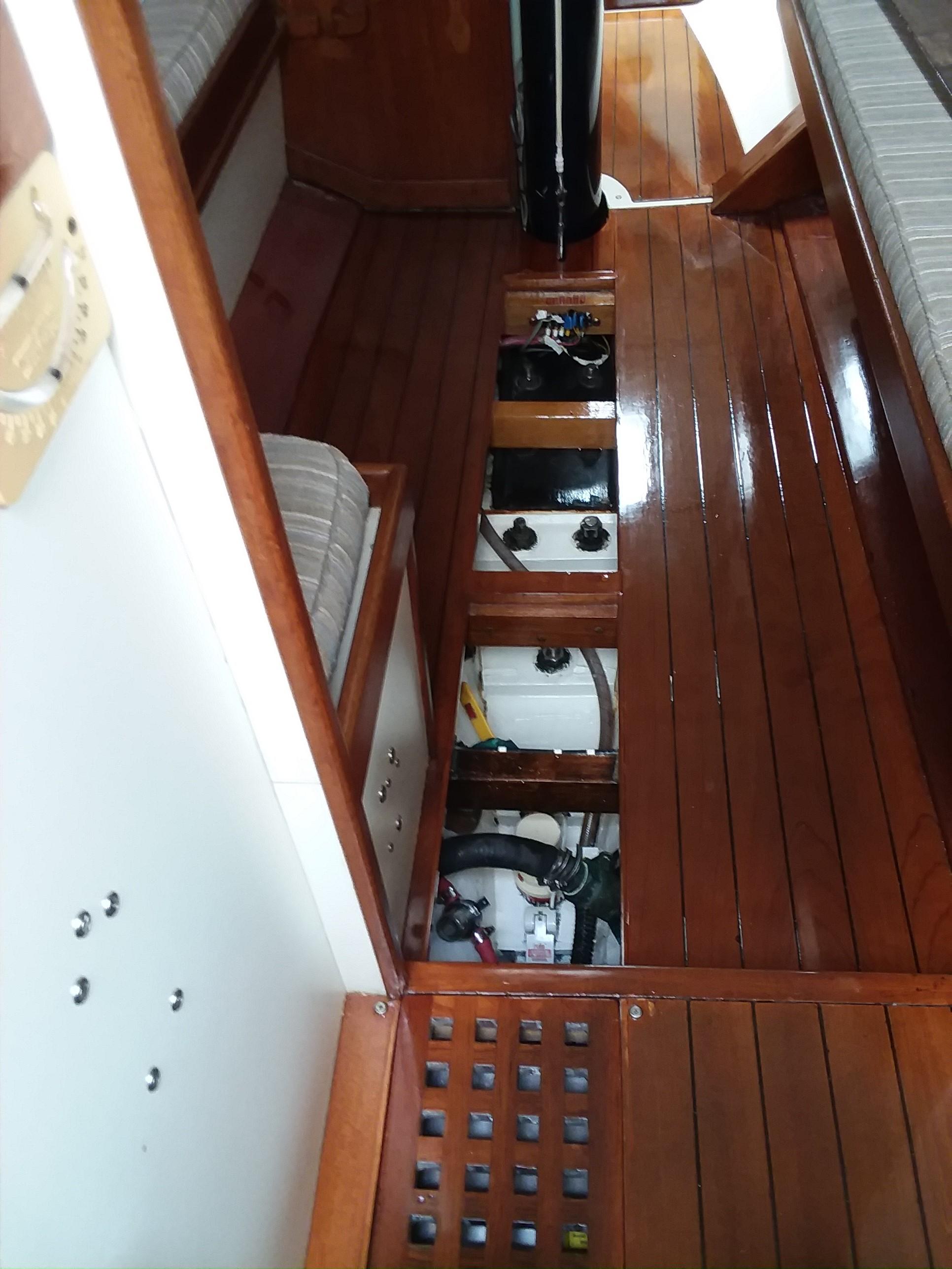 Interior view of a 1972 Tartan 41 sailboat with wooden flooring and open compartments.