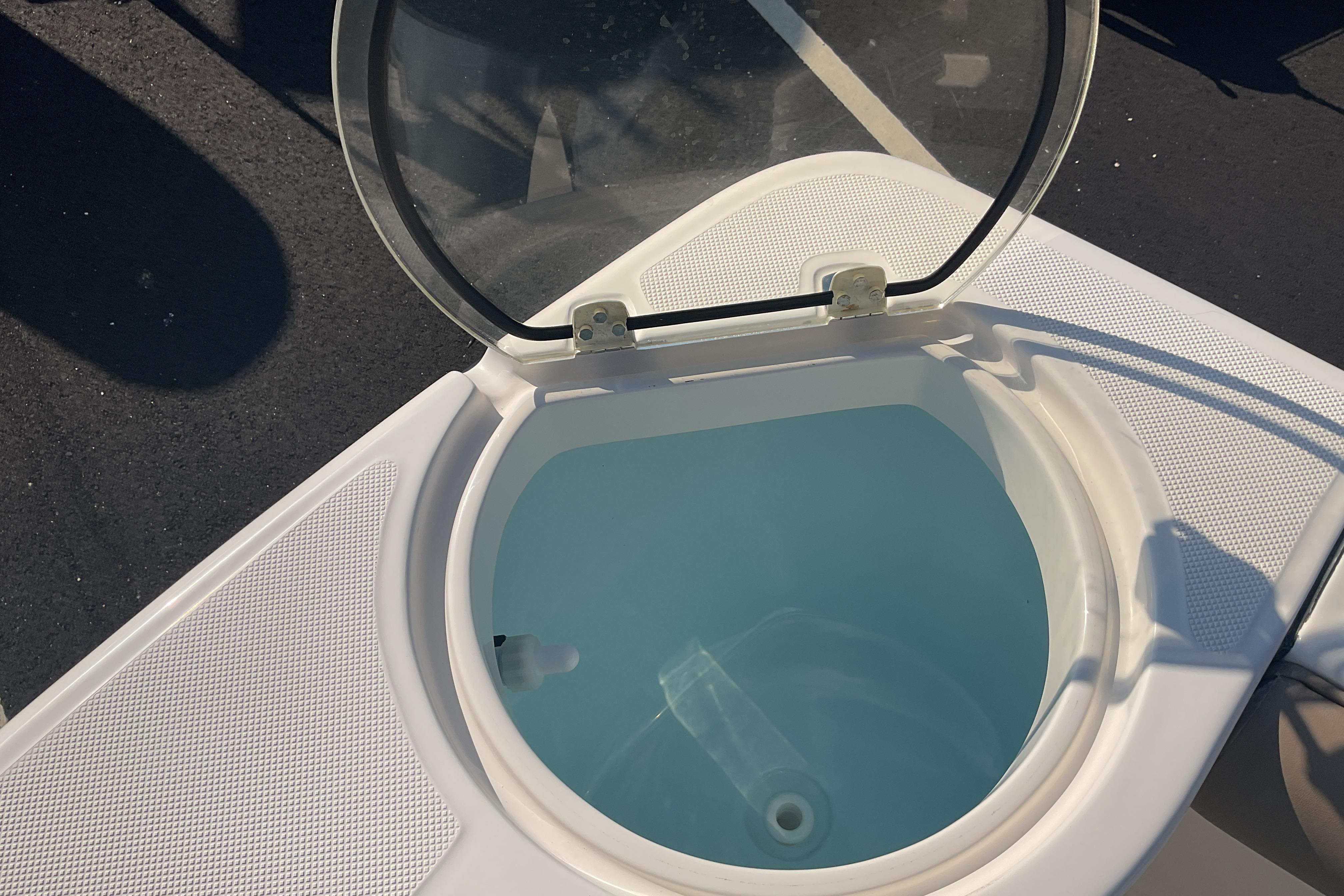 2023 Sea Born SX239 Offshore boat livewell with open lid, showcasing interior design.