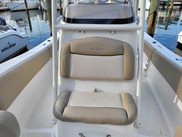 2021 NauticStar 2302 Legacy boat interior with cushioned seating at the dock.