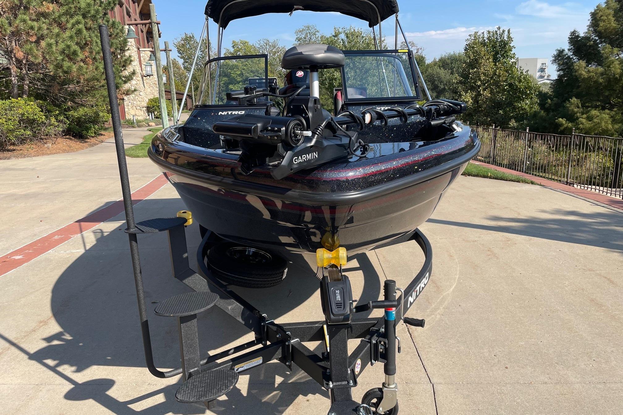 2026 Nitro ZV19 Sport Pro boat on trailer, featuring Garmin equipment, parked outdoors.