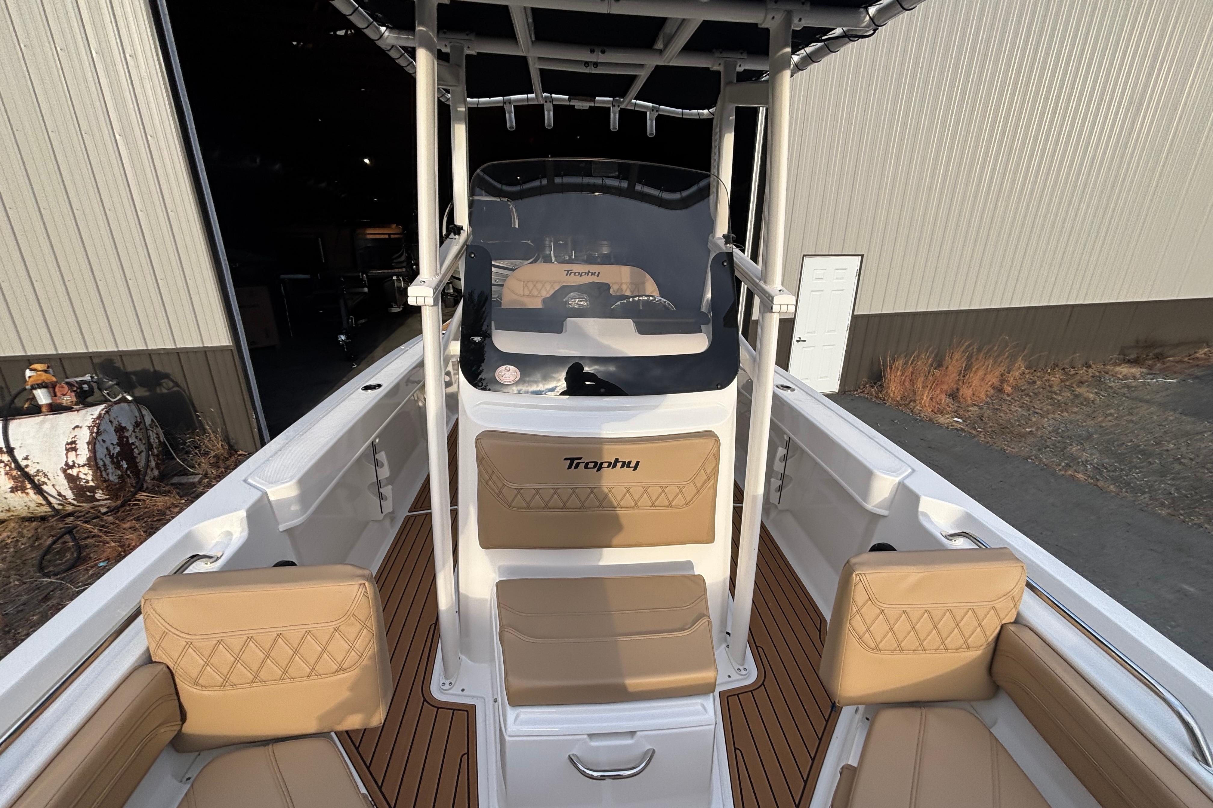 2026 Bayliner Trophy T20CC boat interior with tan seating and wood-style flooring.