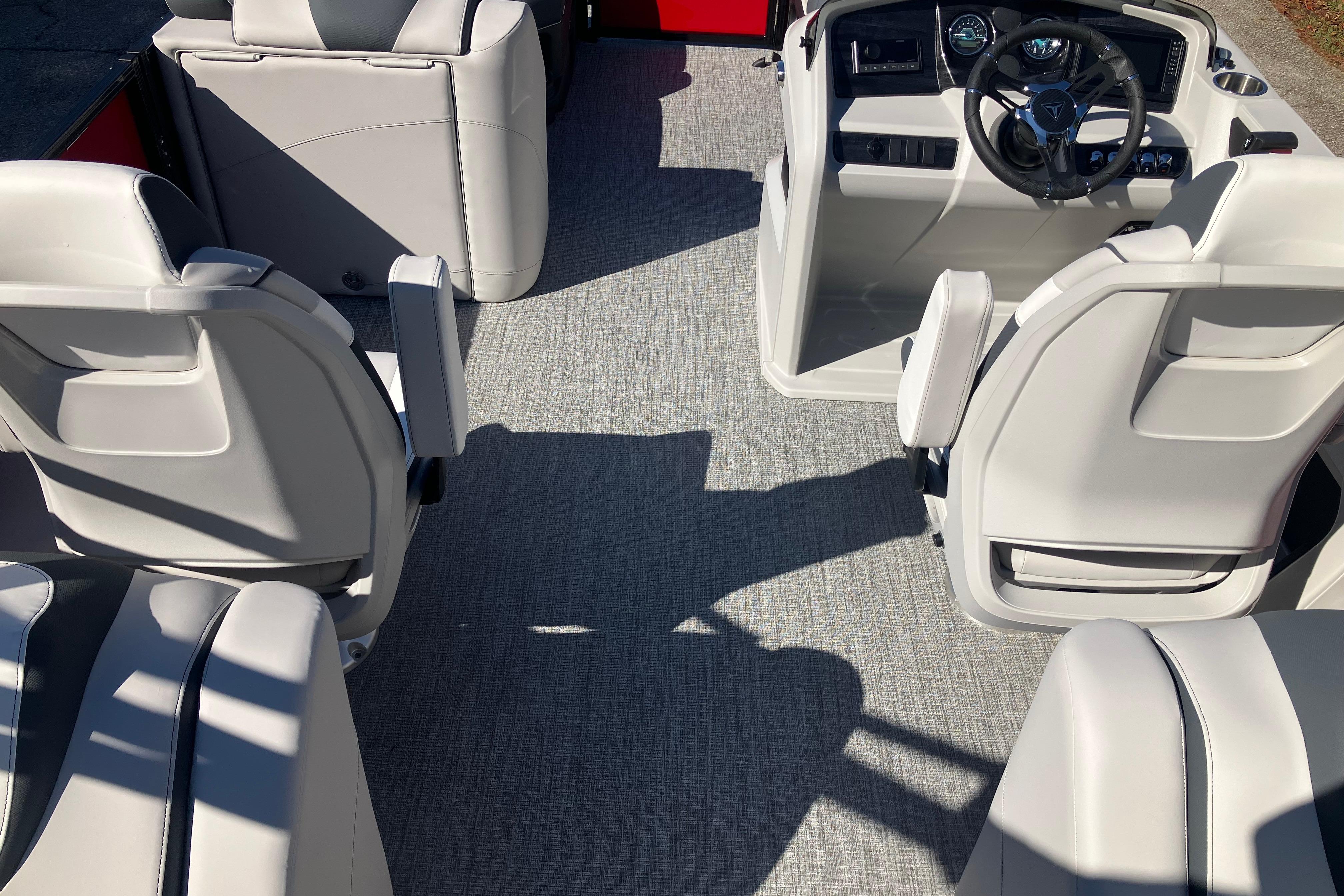 2026 Tahoe Pontoon LTZ Quad Lounger interior with modern seating and steering console.
