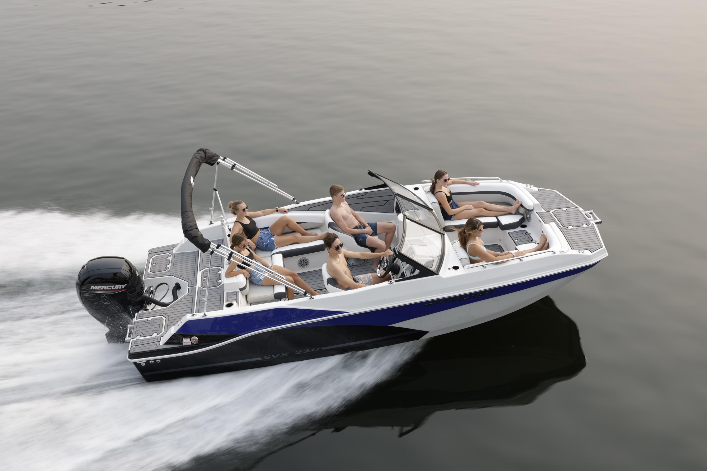 2026 Starcraft SVX 210 DC OB boat cruising with passengers on calm water.