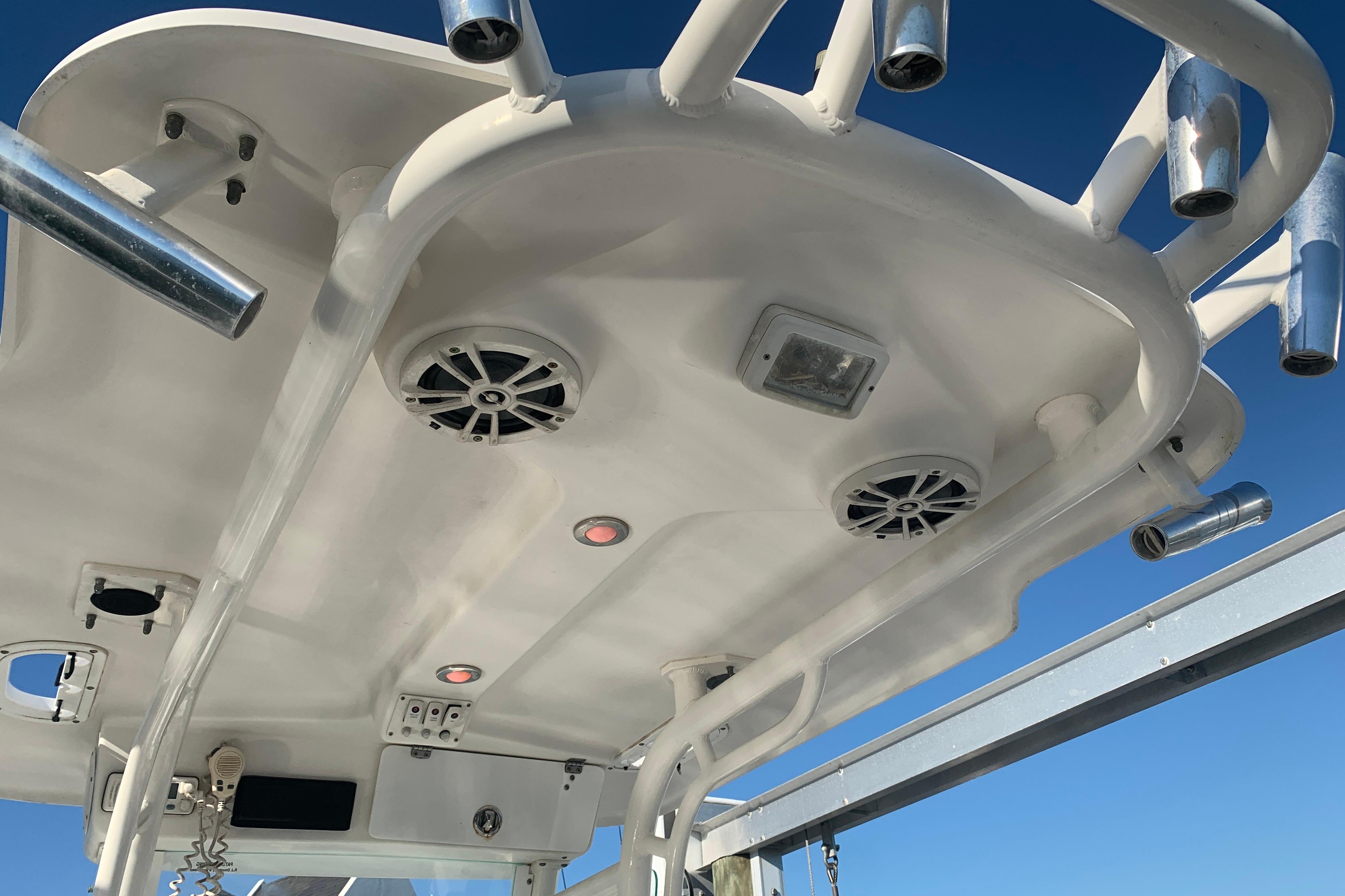 2008 Everglades 223 Center Console boat roof with speakers and rod holders.