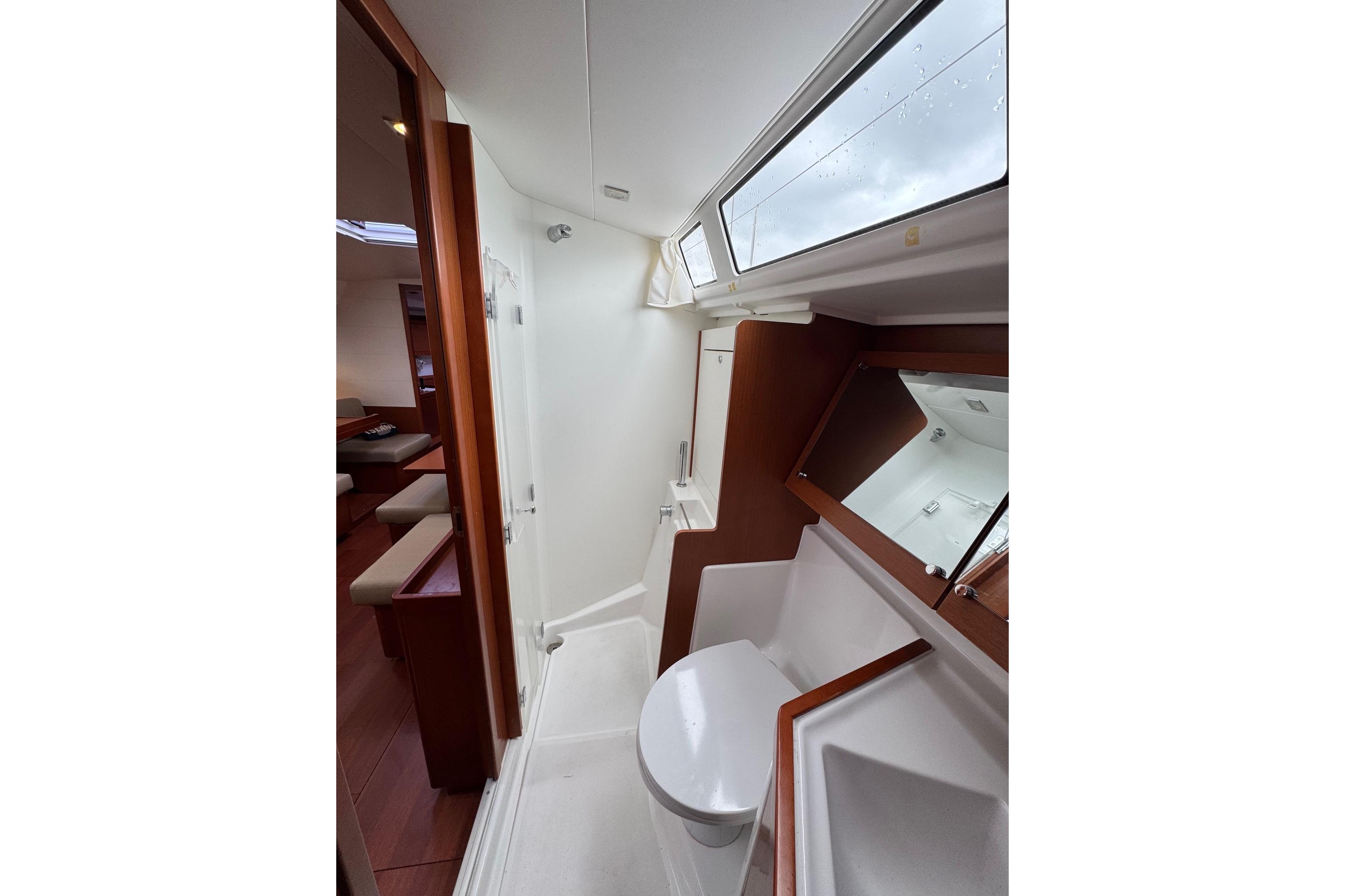 Bathroom interior of 2017 Beneteau Oceanis 45 yacht, featuring modern fixtures and wood accents.