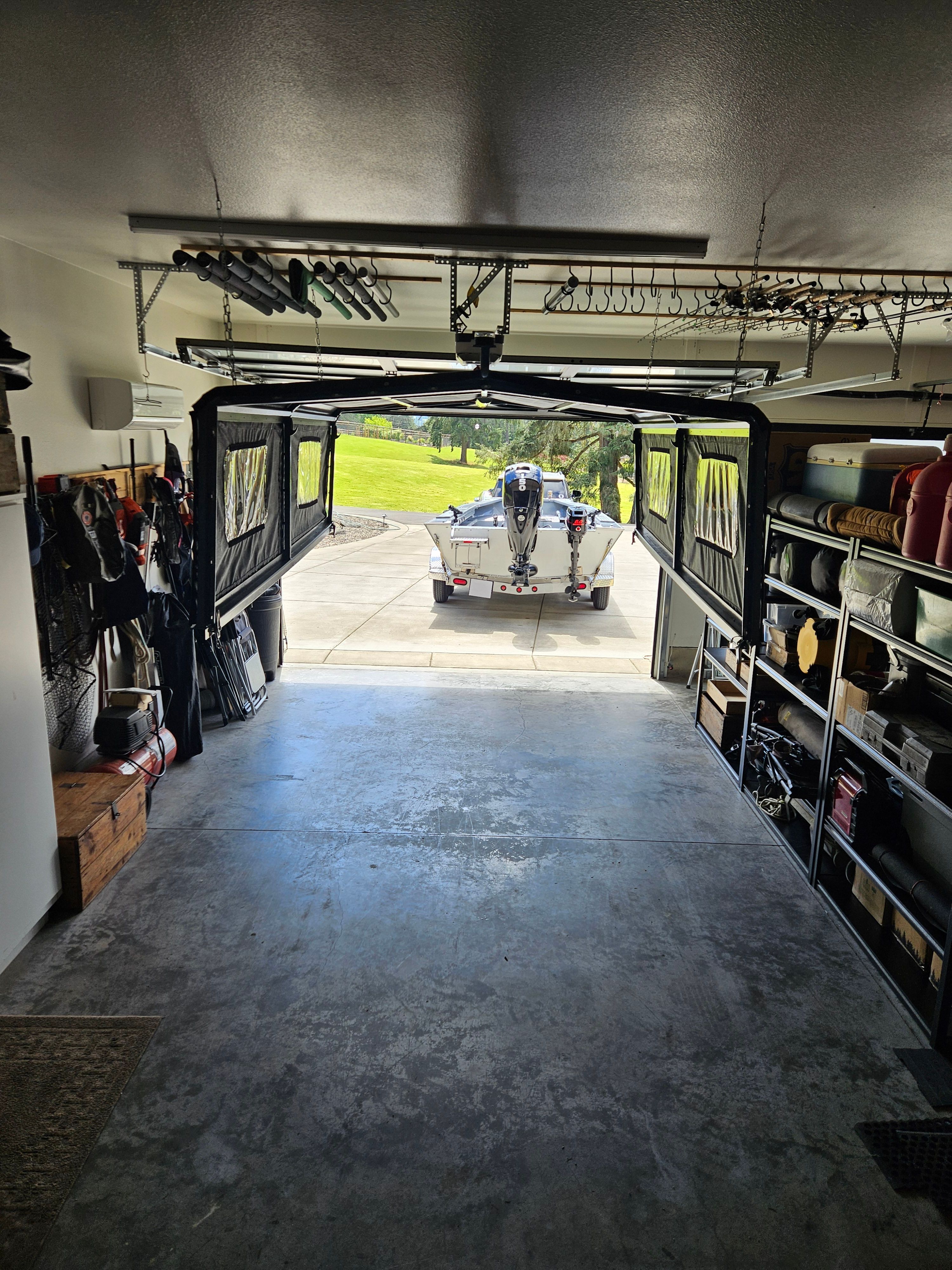 A boat on a trailer in a garage, ready for use.