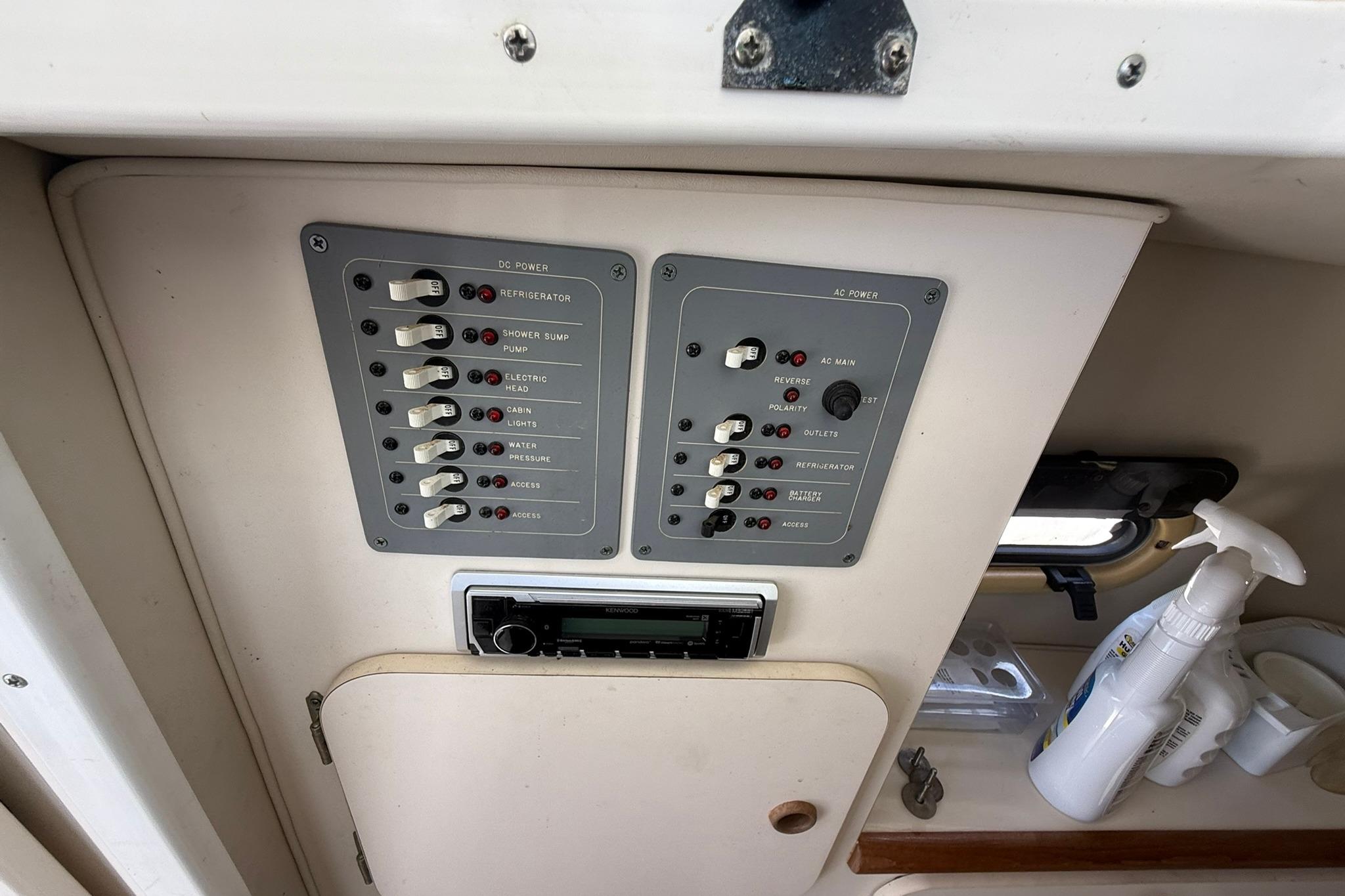 Control panel of a 2003 Pursuit 2870 Walkaround boat, featuring DC and AC power switches.