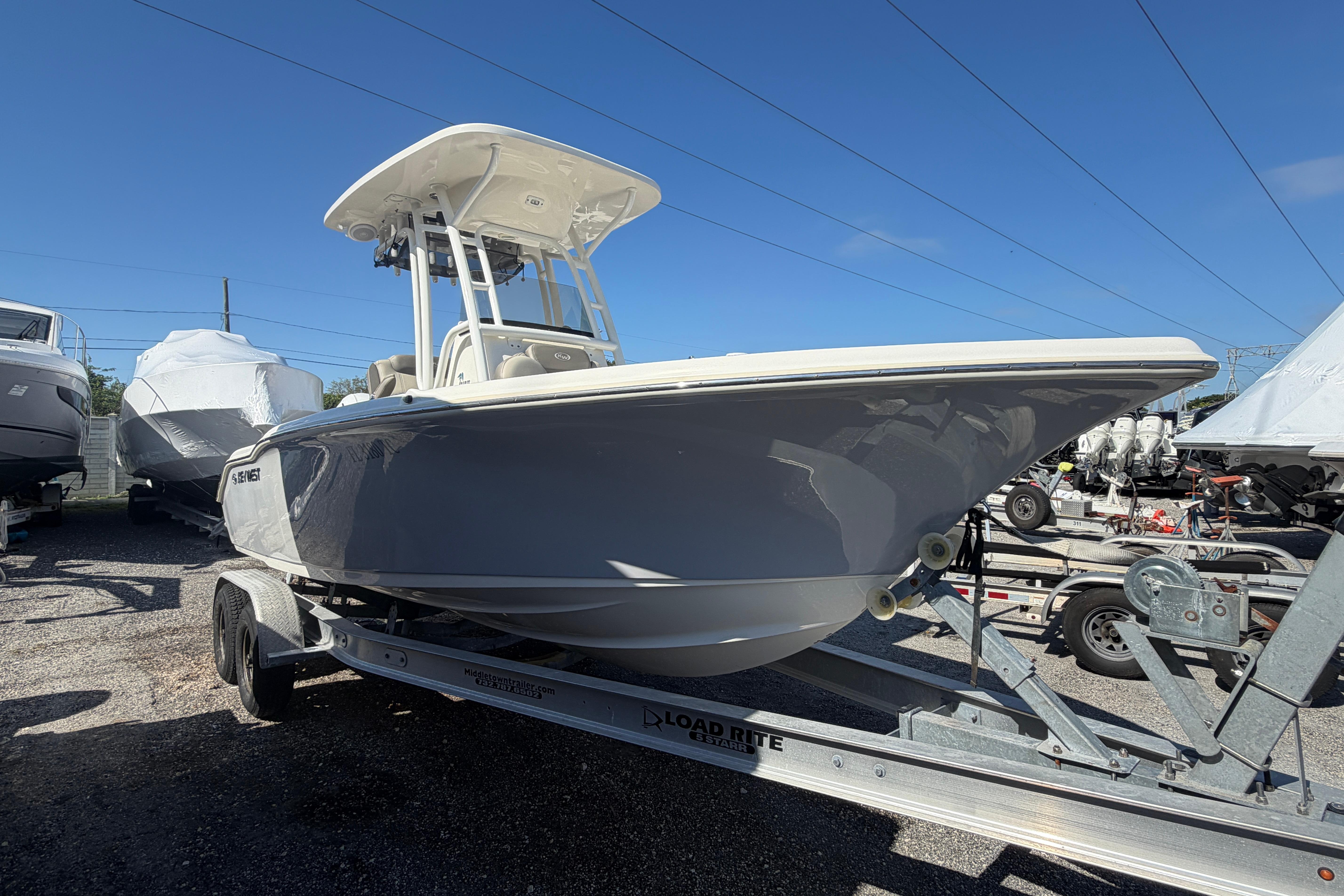 2022 Key West 219 FS boat on trailer under clear blue sky.