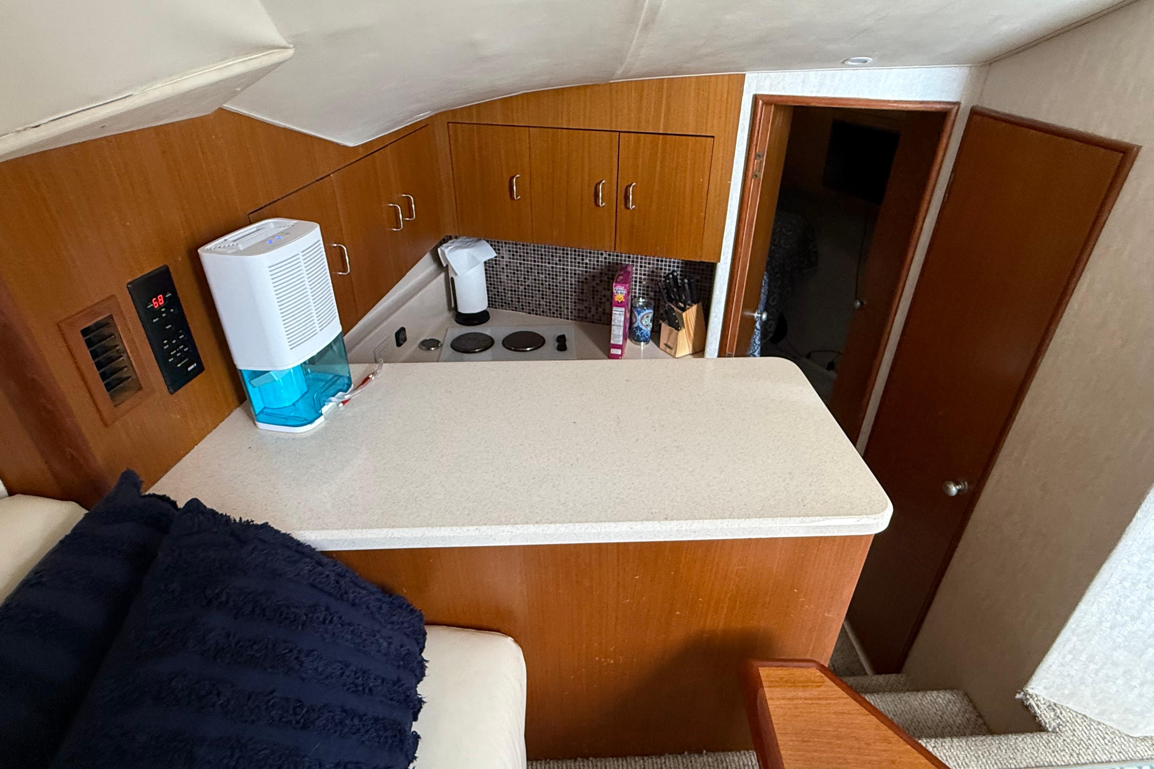 1999 Ocean Yachts 40 Express interior kitchen with wooden cabinets and modern appliances.