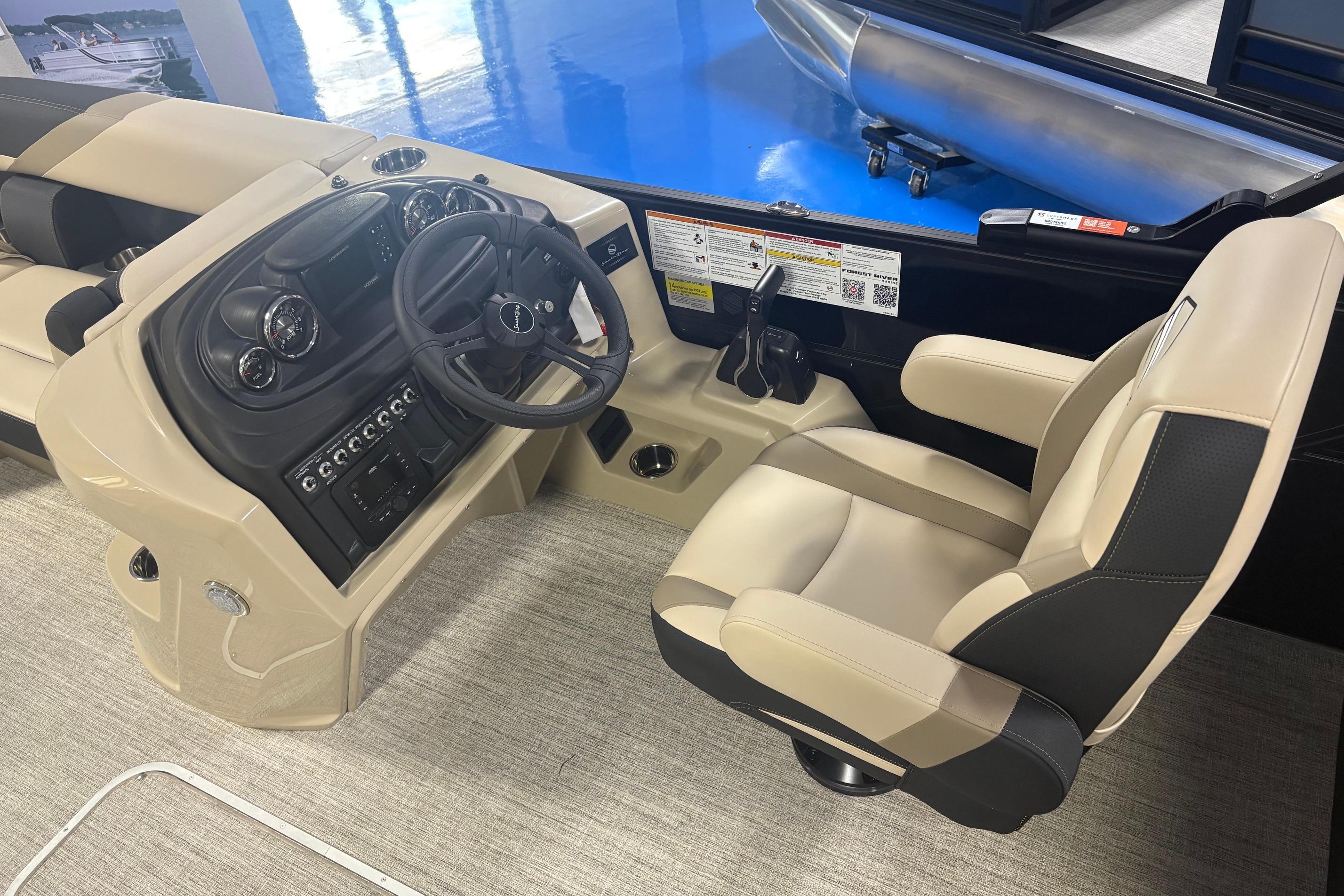 2026 South Bay S224RS boat interior with steering wheel and captain's chair.