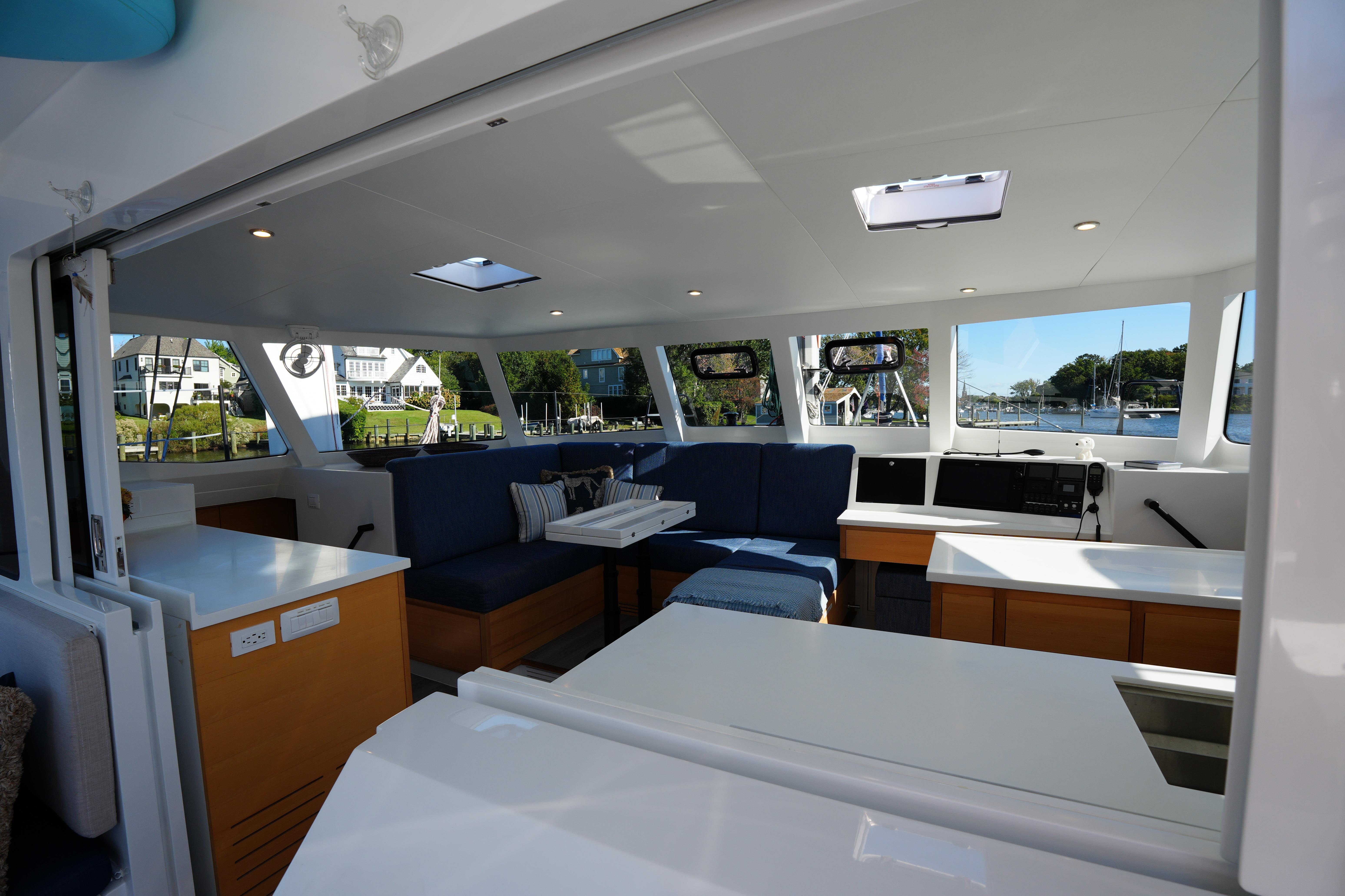 Luxurious interior of 2024 Balance 442 yacht with modern seating and panoramic windows.