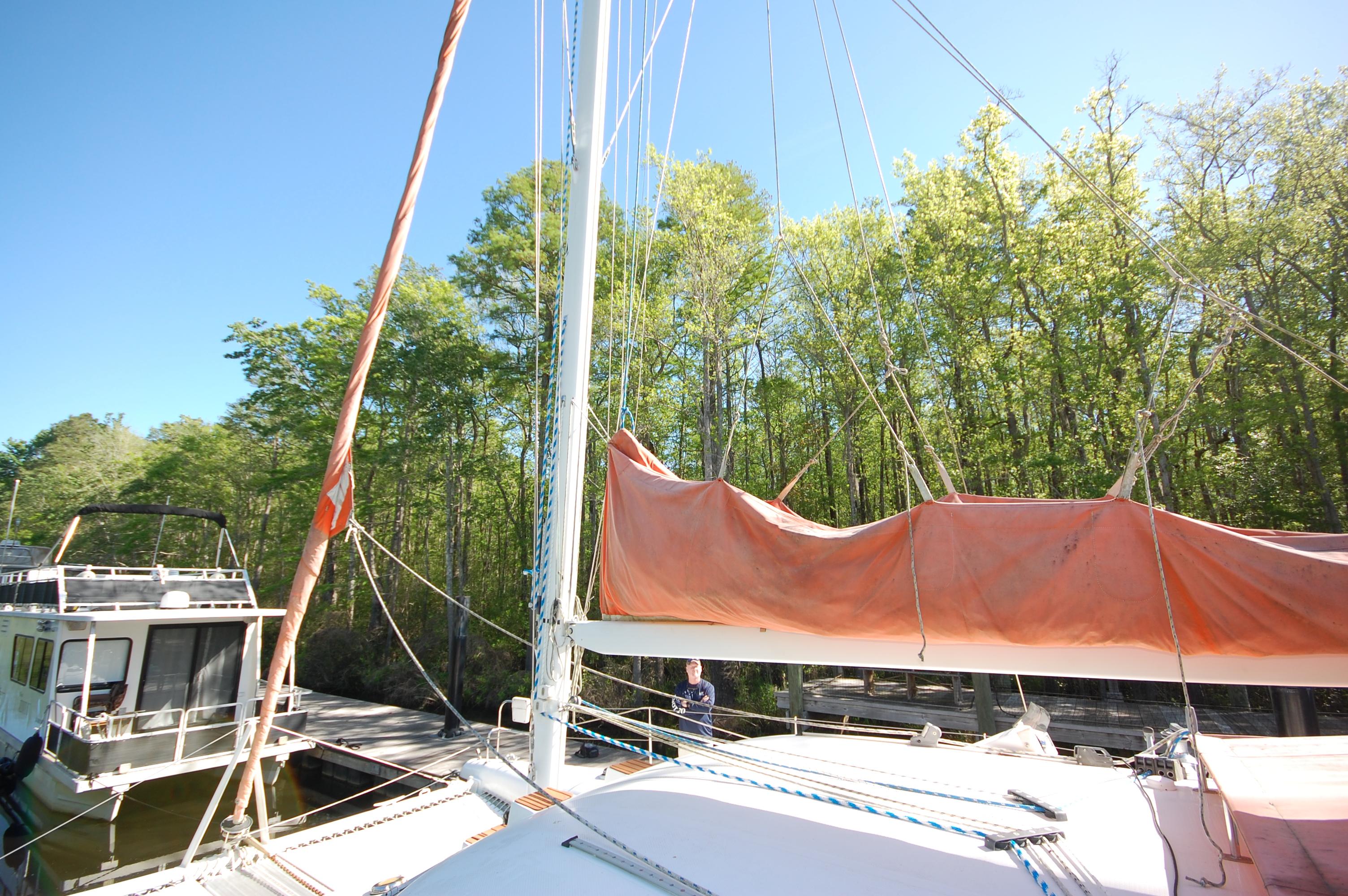 1999 Wildcat 35 Catamaran docked near a forested area.