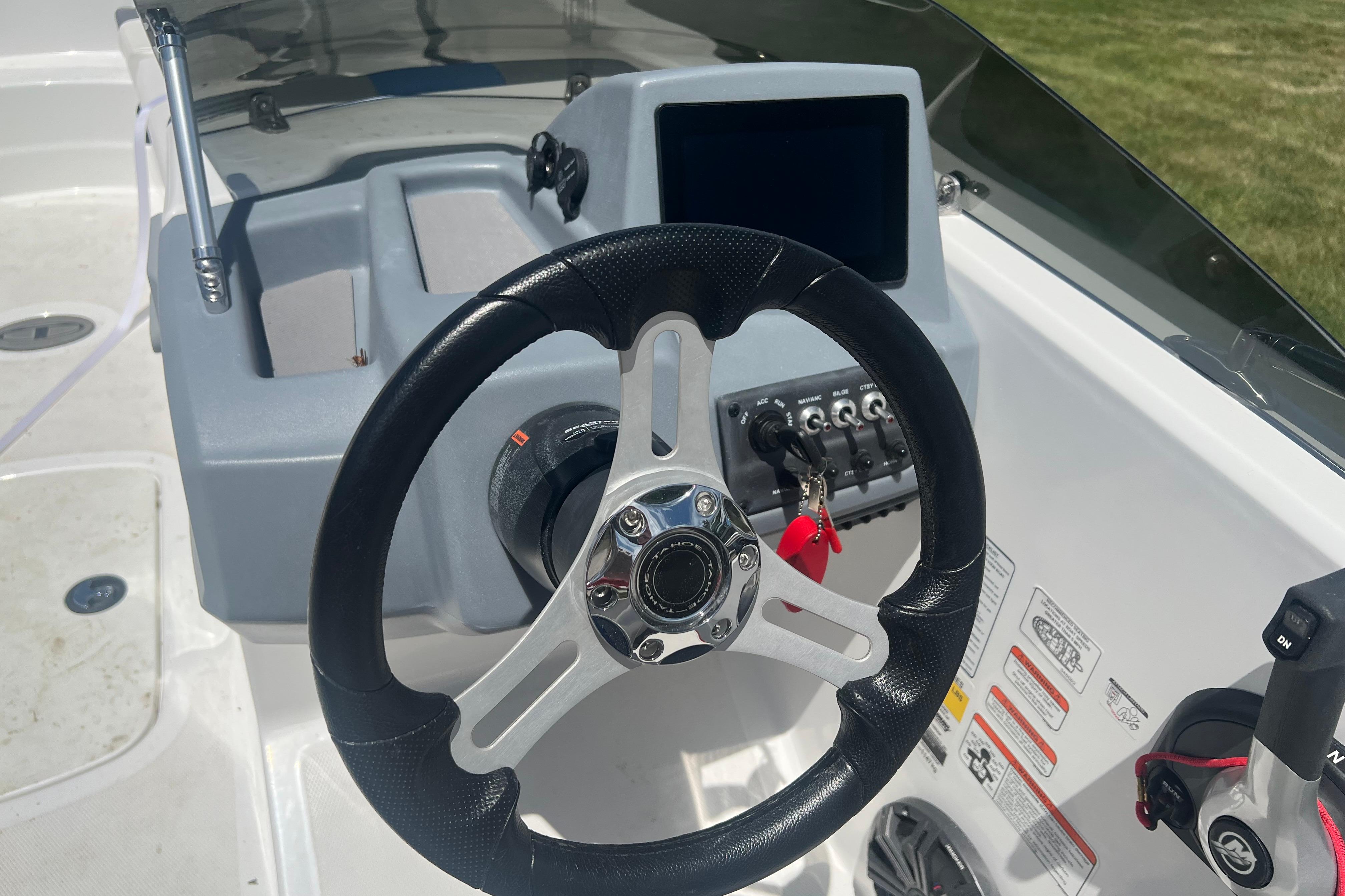 2023 Tahoe T18 boat dashboard with steering wheel and control panel.