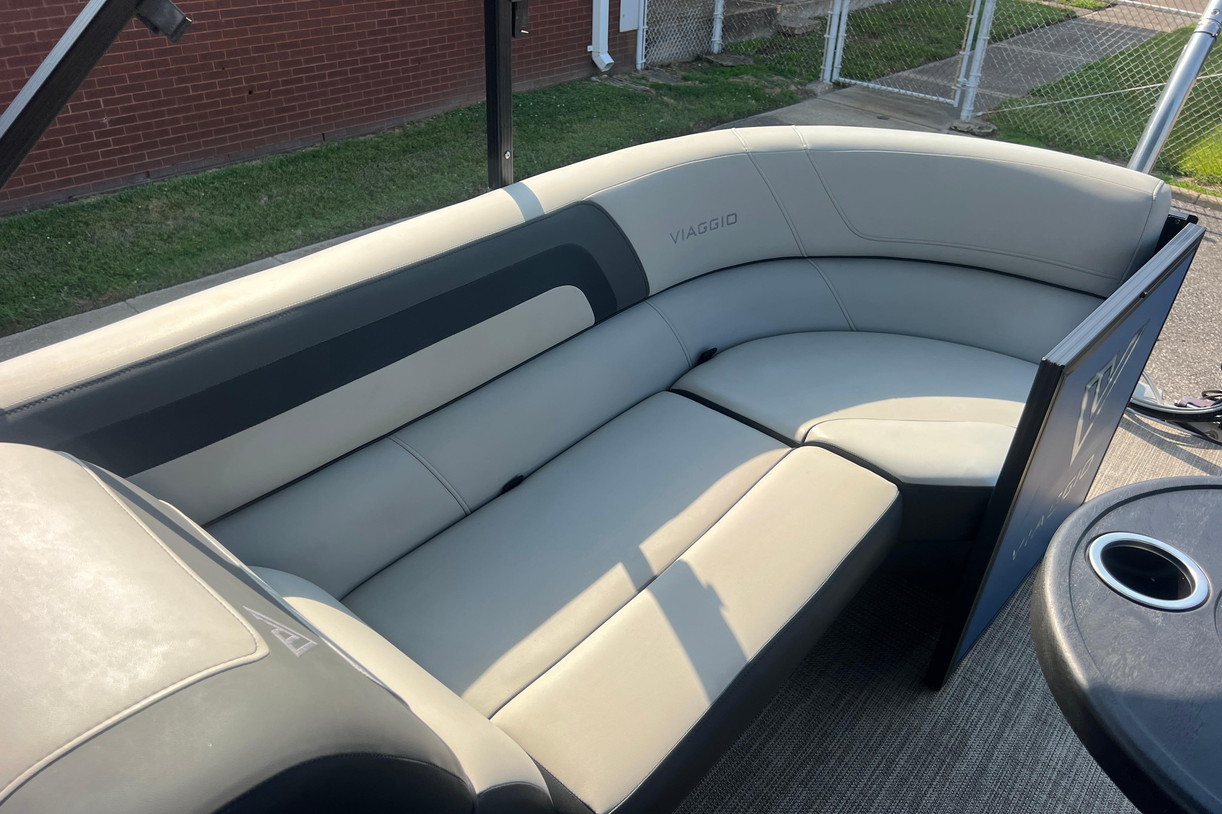 Luxurious seating on 2022 Viaggio Lago V-U 22 pontoon boat, featuring sleek gray upholstery.