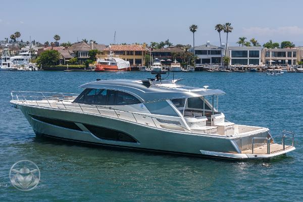 2025 Riviera 645 SUV luxury yacht cruising in a marina.