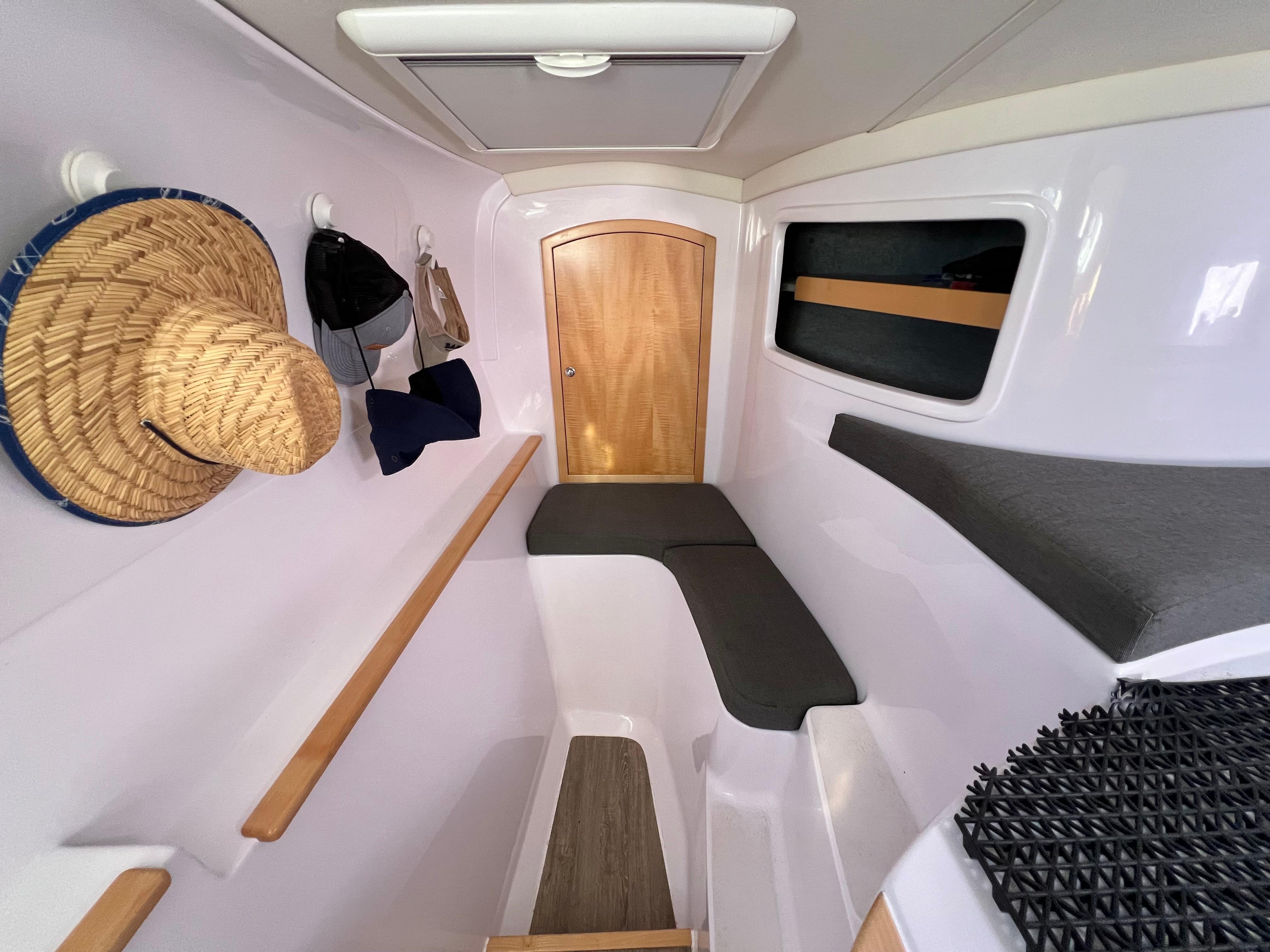Interior of 2020 Seawind 1260 yacht, featuring seating, storage, and hanging hats.