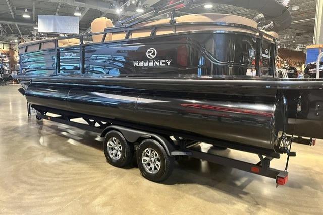 2026 Regency 230 DL pontoon boat on trailer in showroom setting.