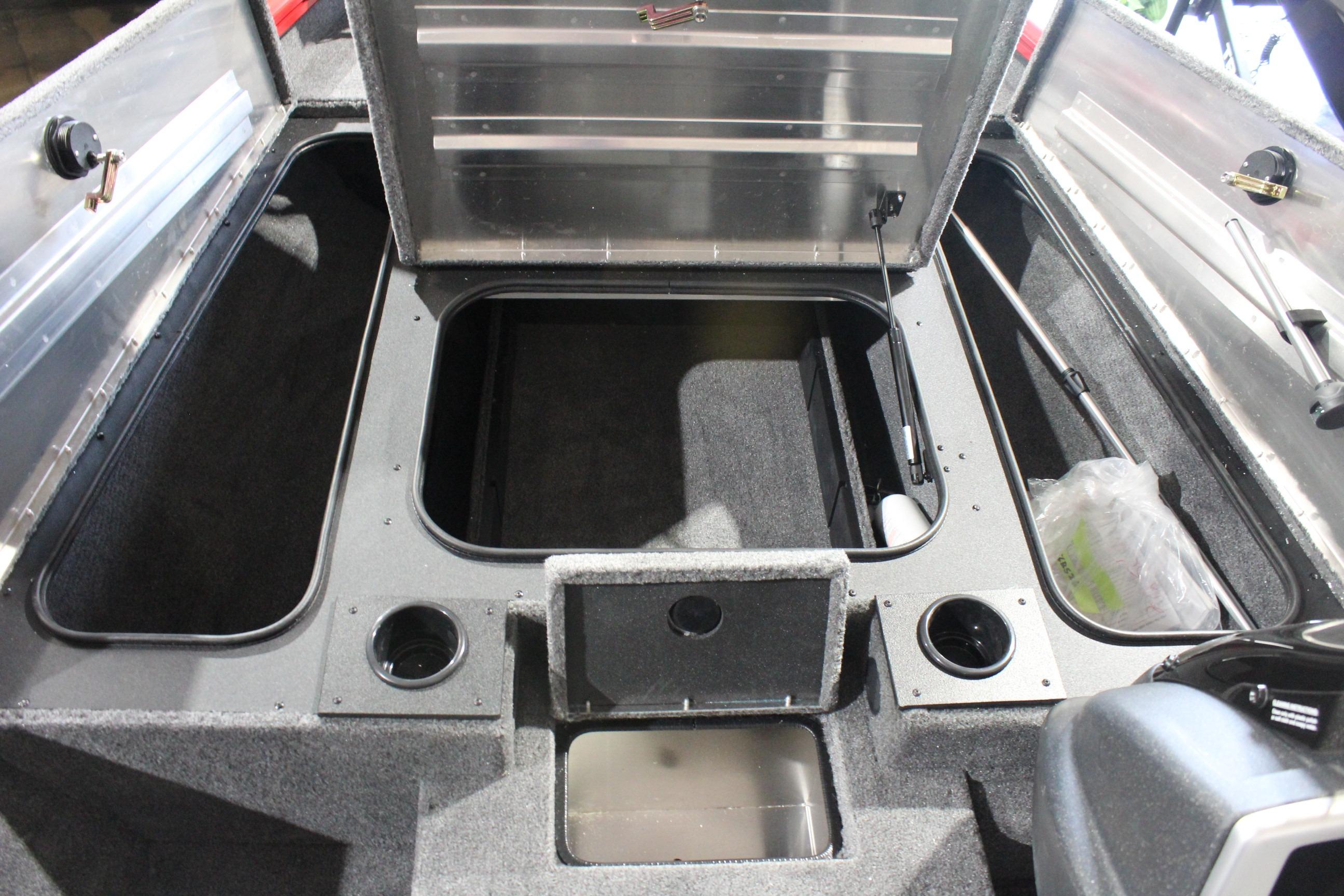 2026 Tracker Pro Team 175 boat interior with open storage compartments and cup holders.