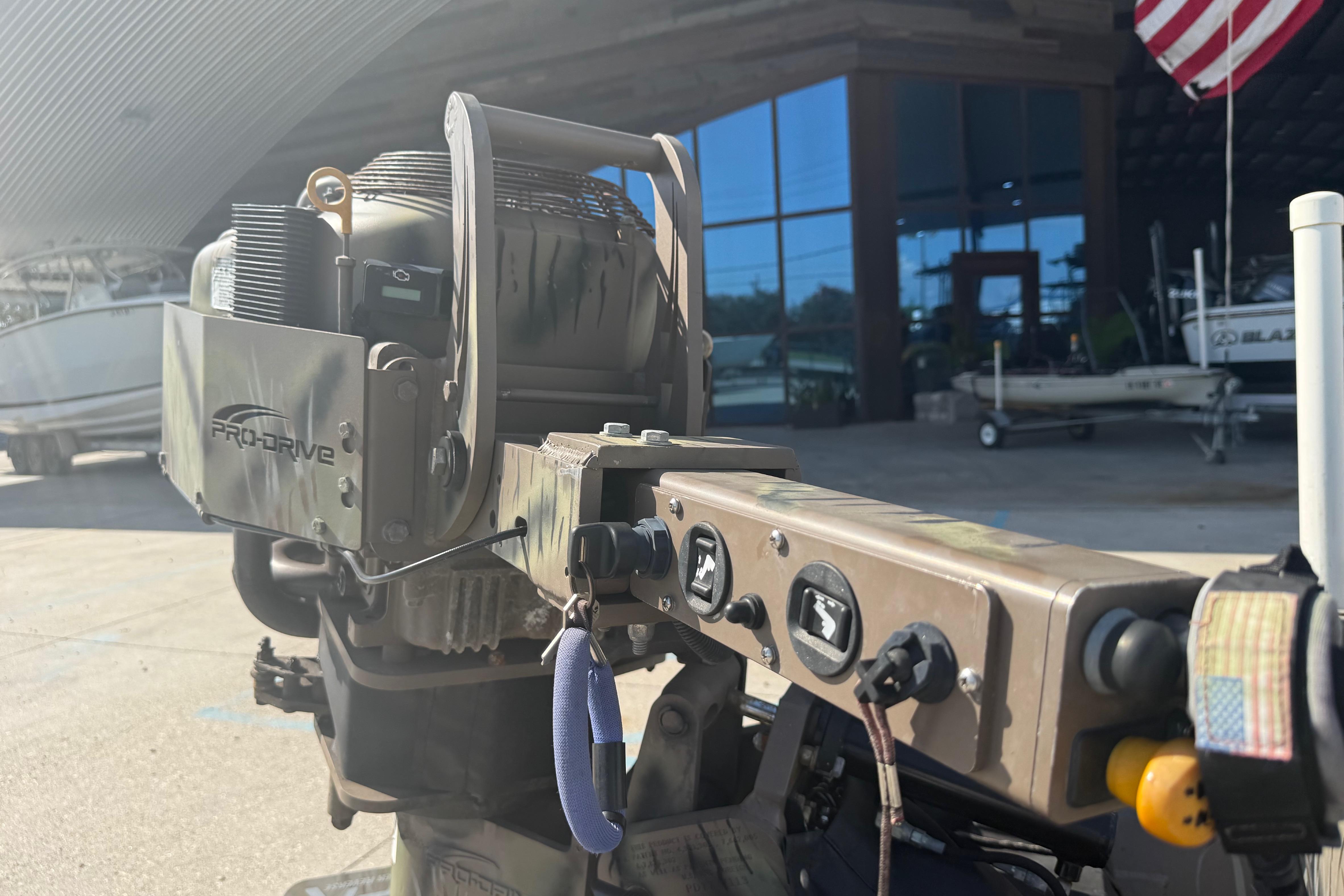 Pro-Drive 2048 outboard motor, 2017 model, in a boatyard setting with American flag.
