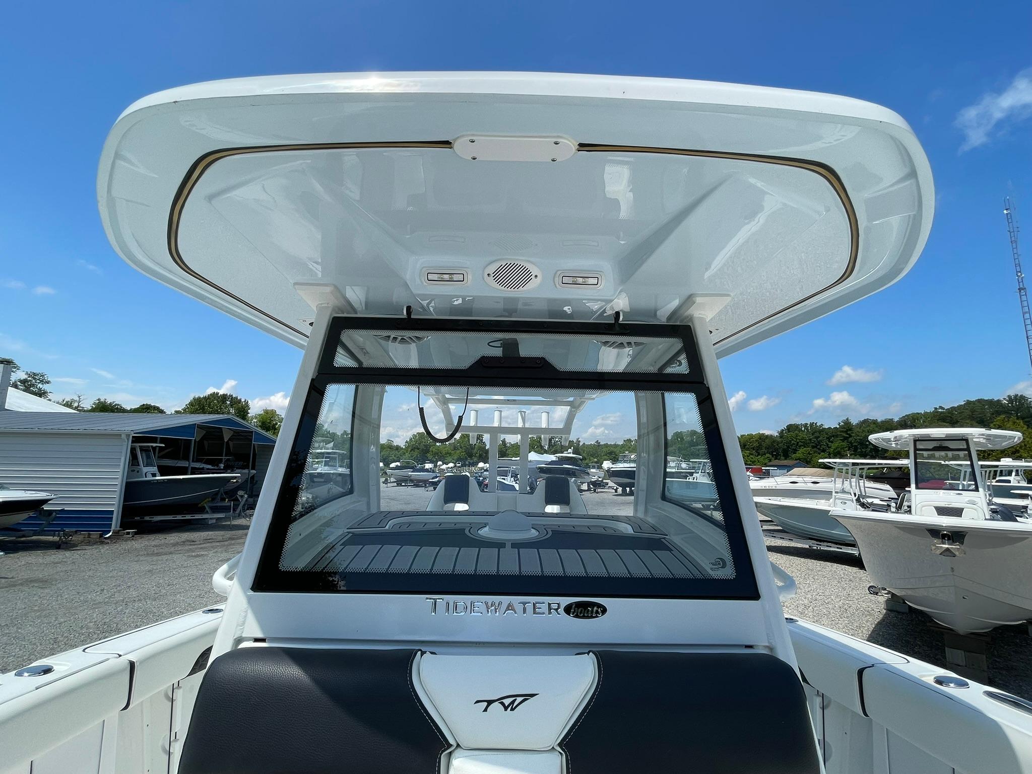 2026 Tidewater 302 CC Adventure boat, sleek design, docked under clear blue sky.