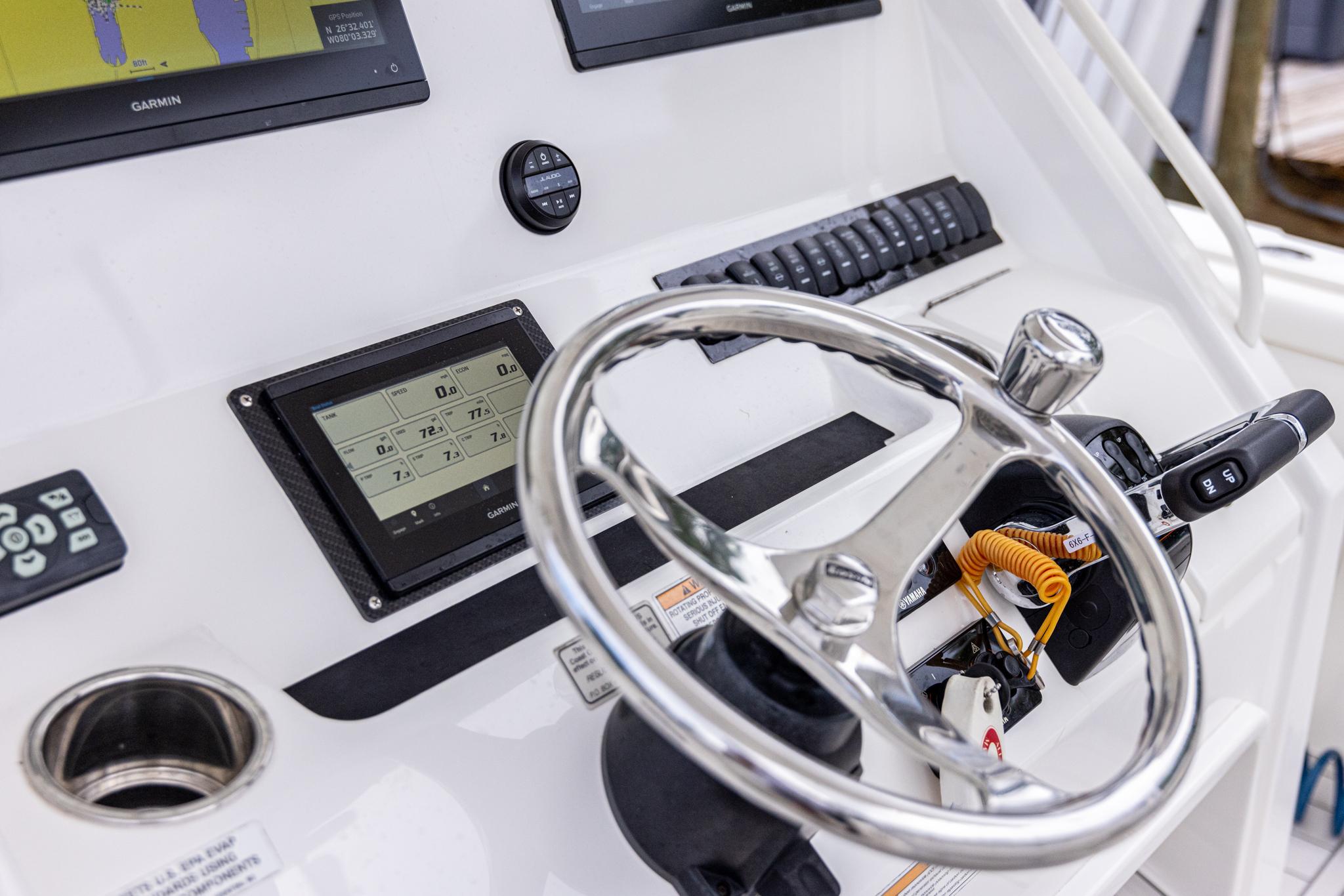 2019 Regulator 34 boat helm with steering wheel and navigation controls.