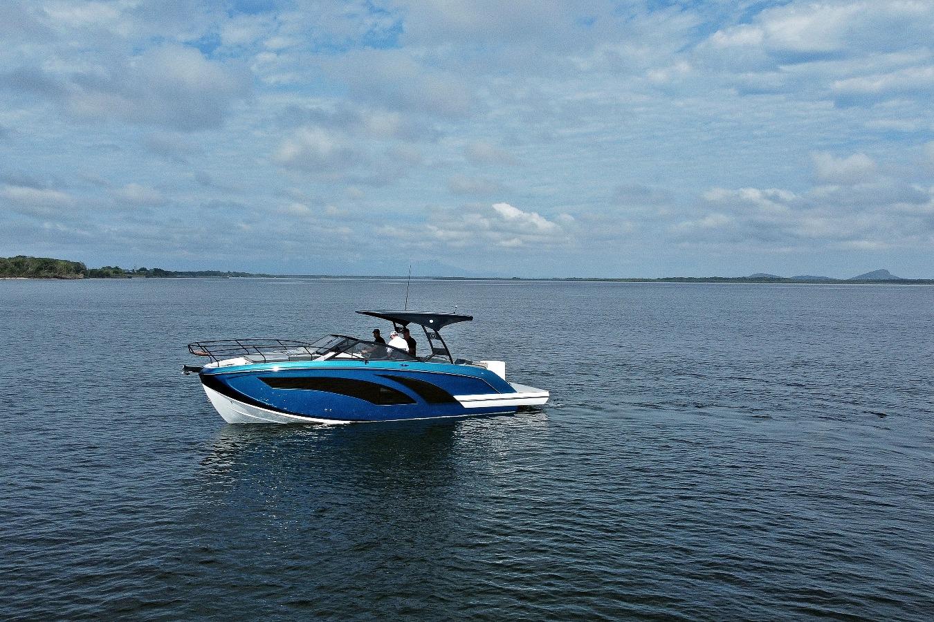 Modern Hanover 327 boat cruising on open water under a partly cloudy sky, 2026 model.