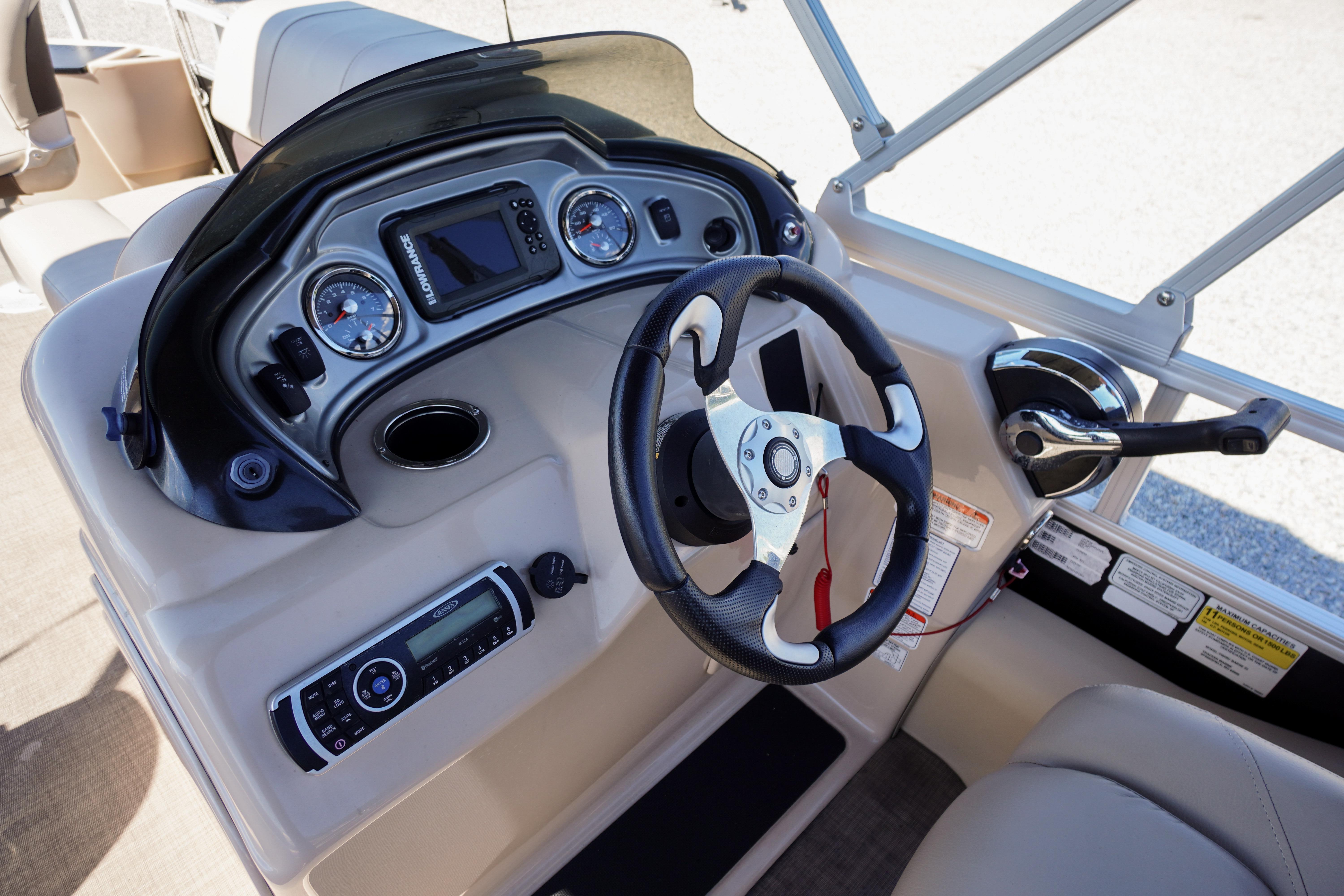 2019 SUNTRACKER Fishin' Barge 22 DLX dashboard with steering wheel and control panel.
