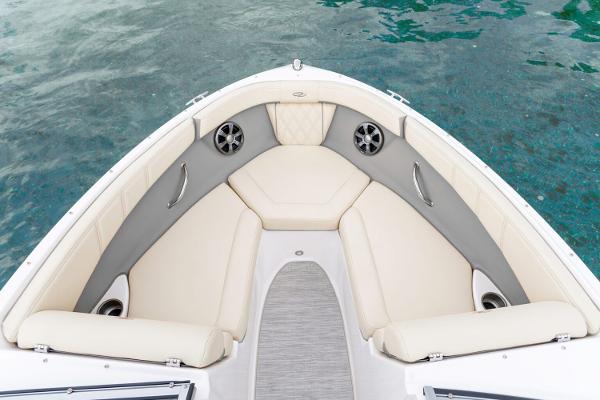 Manufacturer Provided Image: Bow seating area of 2026 Regal 2000 ES boat with beige cushions and speakers.