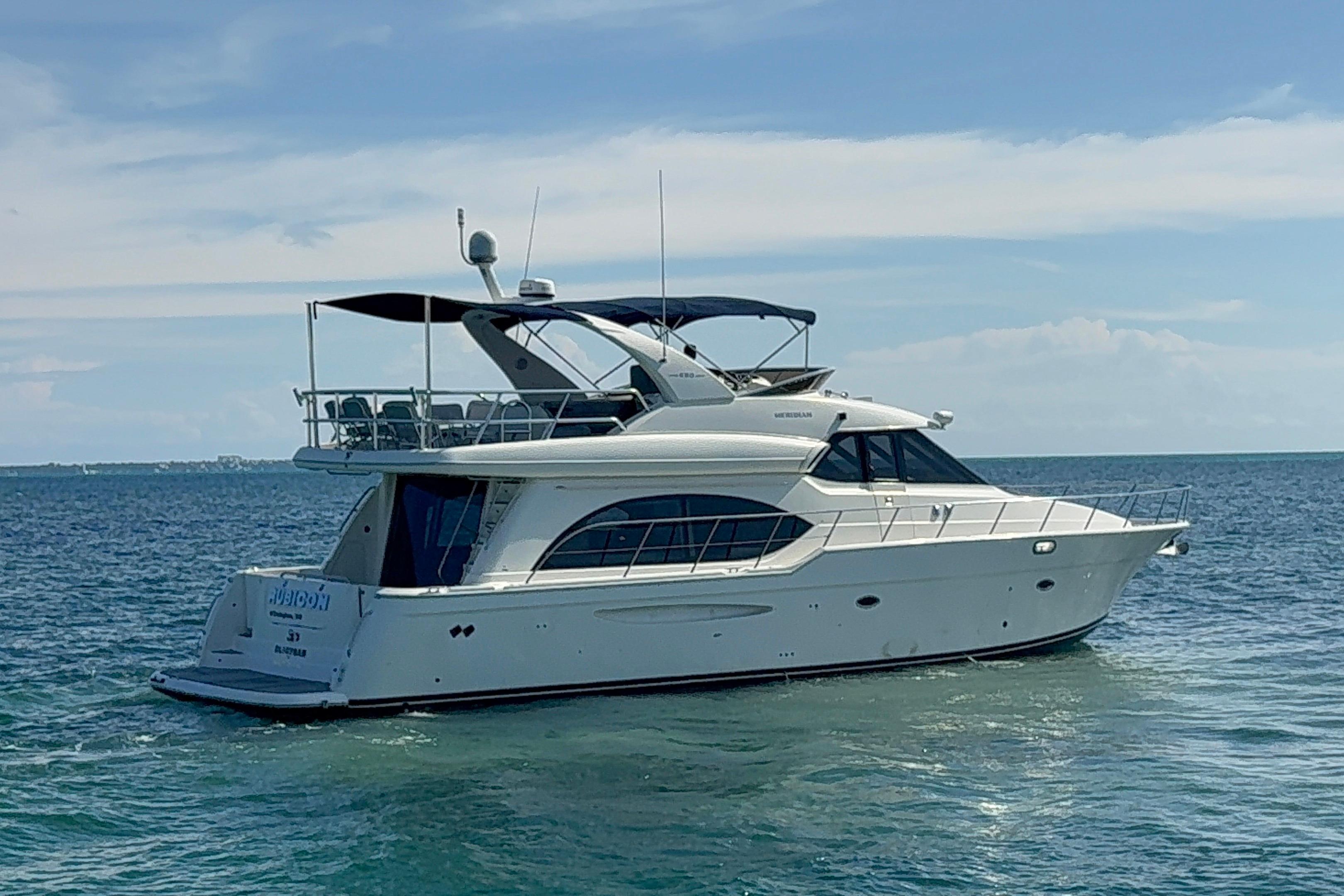 2008 Meridian 580 Pilothouse yacht cruising on open water under a clear sky.