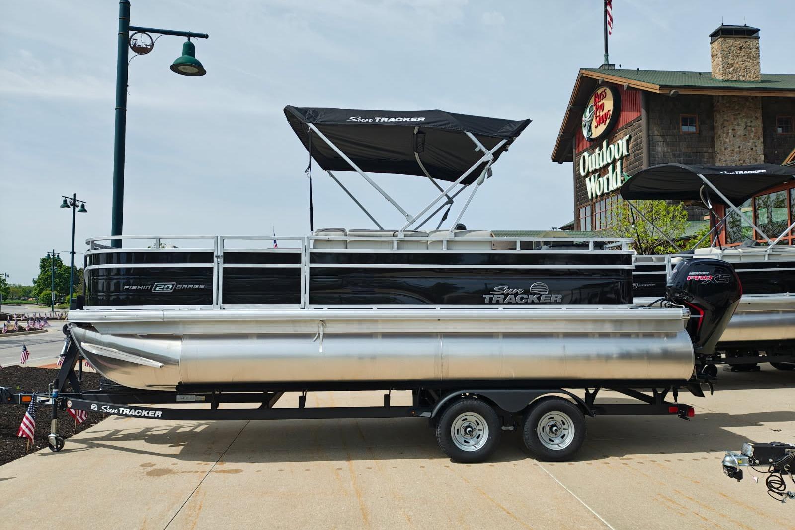2026 Sun Tracker Fishin' Barge 20 DLX pontoon boat displayed outdoors.