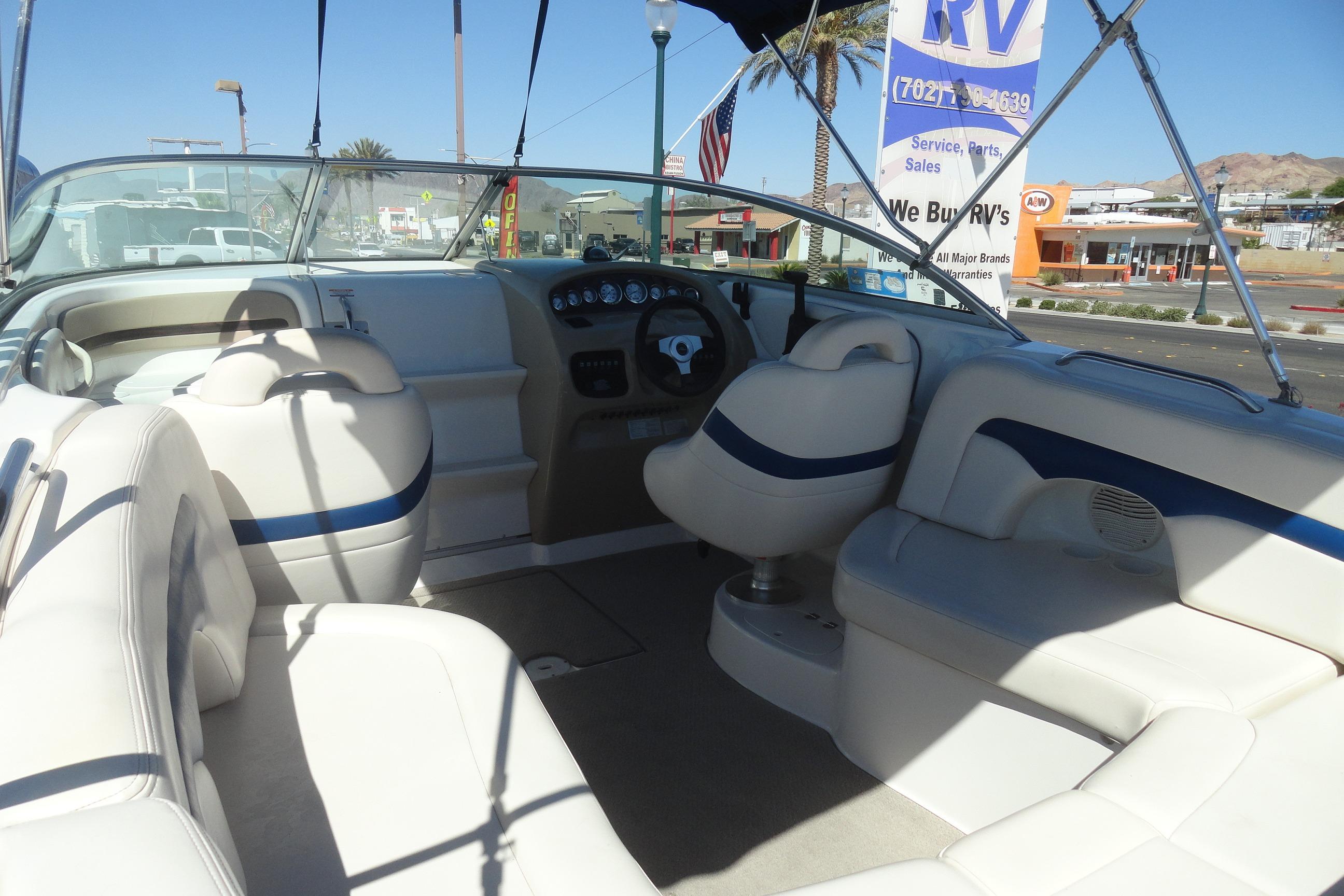 Interior of a 2001 Chaparral 265 SSi boat with white seating and dashboard view.