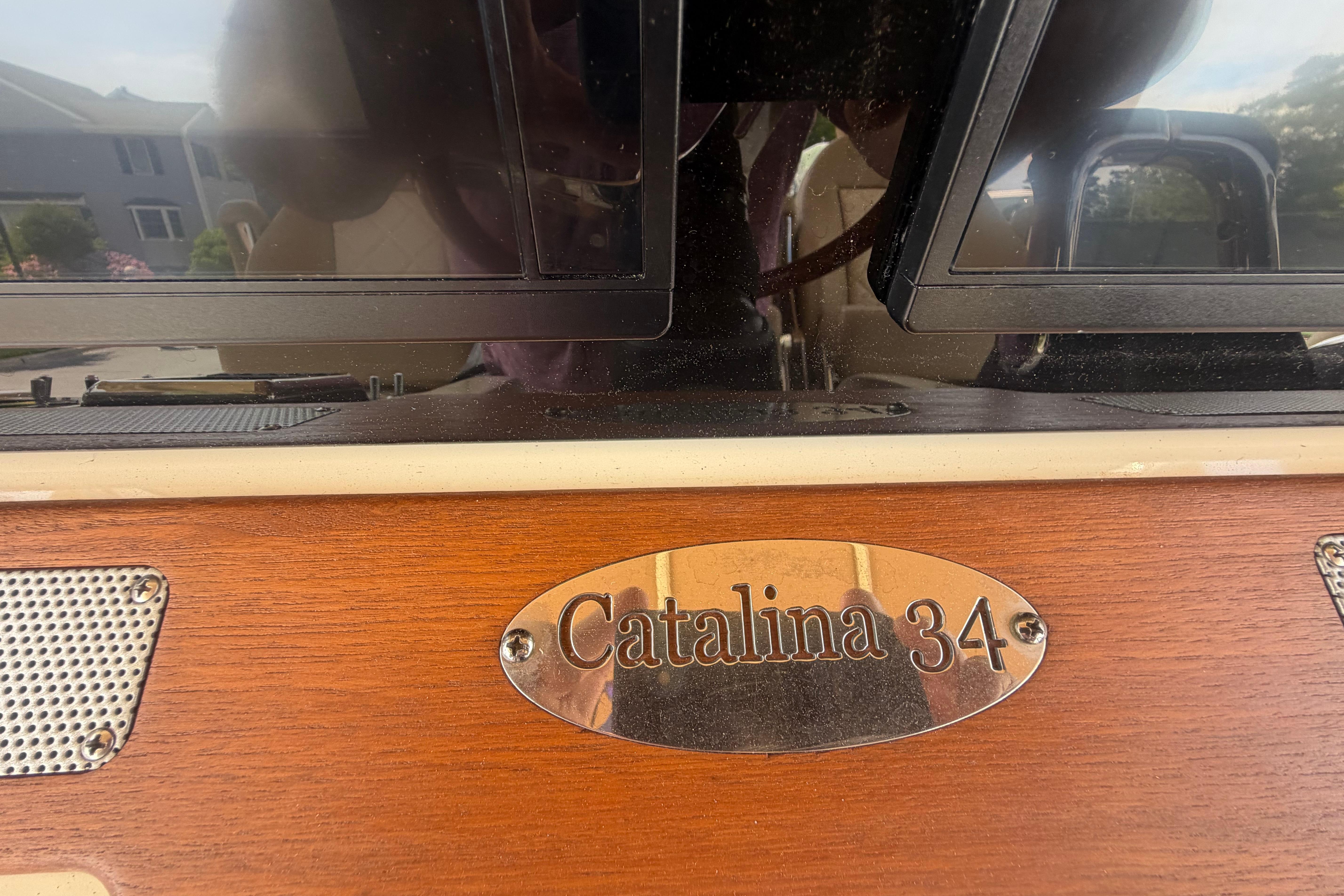 2017 Chris-Craft Catalina 34 nameplate on wooden panel, showcasing luxury boat design.