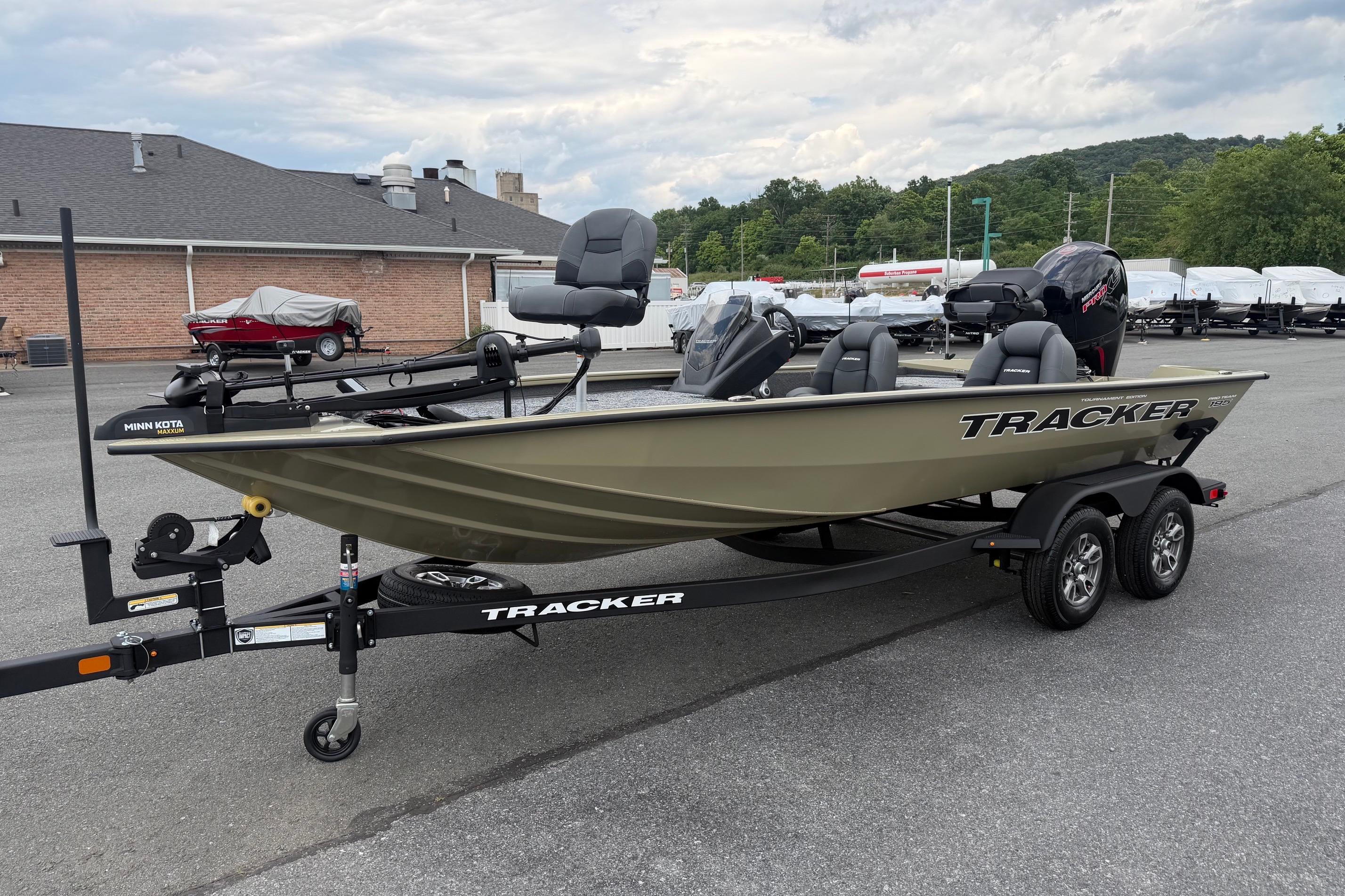 2026 Tracker Pro Team 195 boat on trailer, parked outdoors, showcasing sleek design and modern features.
