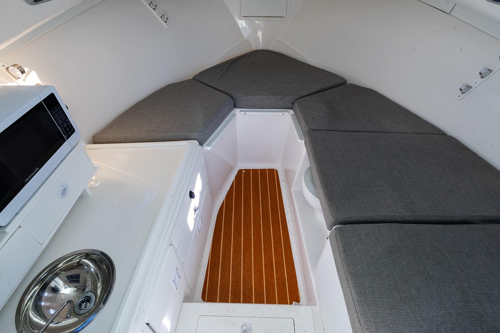 2024 Steiger Craft 31 Fisherman cabin interior with seating, microwave, and sink.