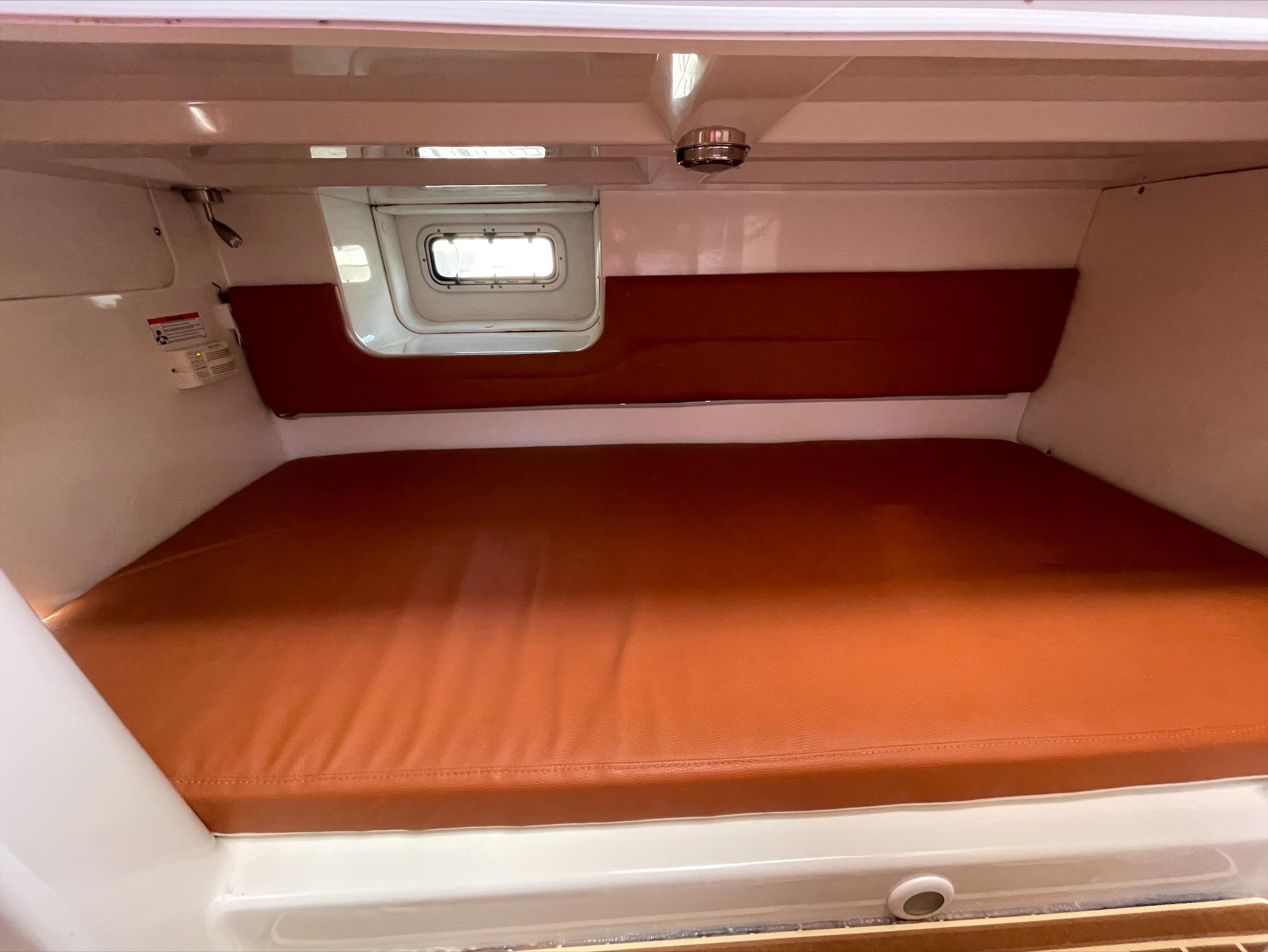 Interior of a Pro-Line 32 Express with brown upholstery and a small window.