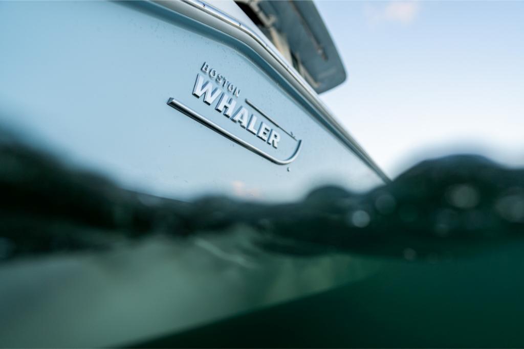 Close-up of 2024 Boston Whaler 280 Dauntless boat partially submerged in water.