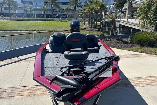 2026 Tracker Pro Team 175 boat docked near a waterfront with palm trees.